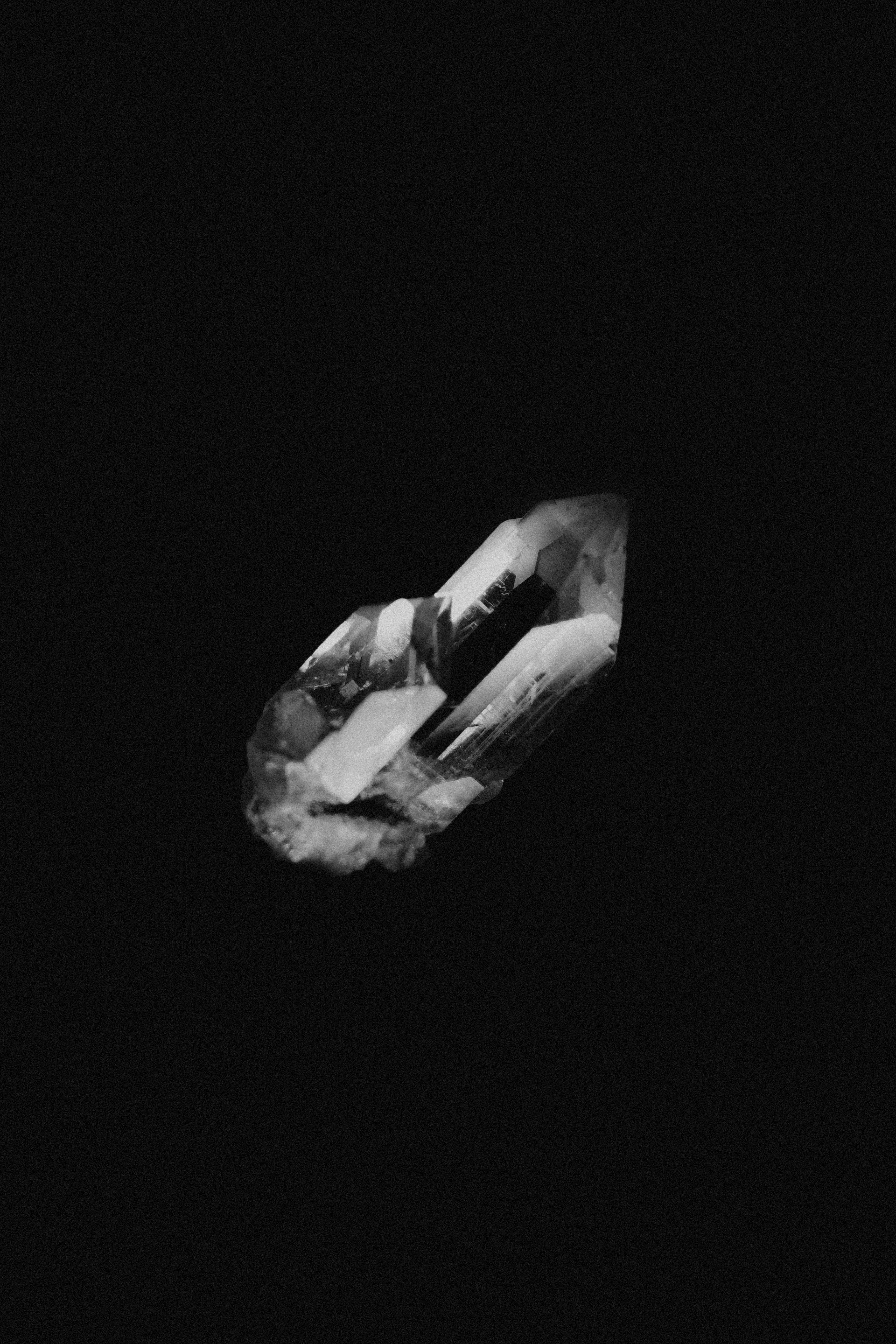 A crystal against a dark, black background.
