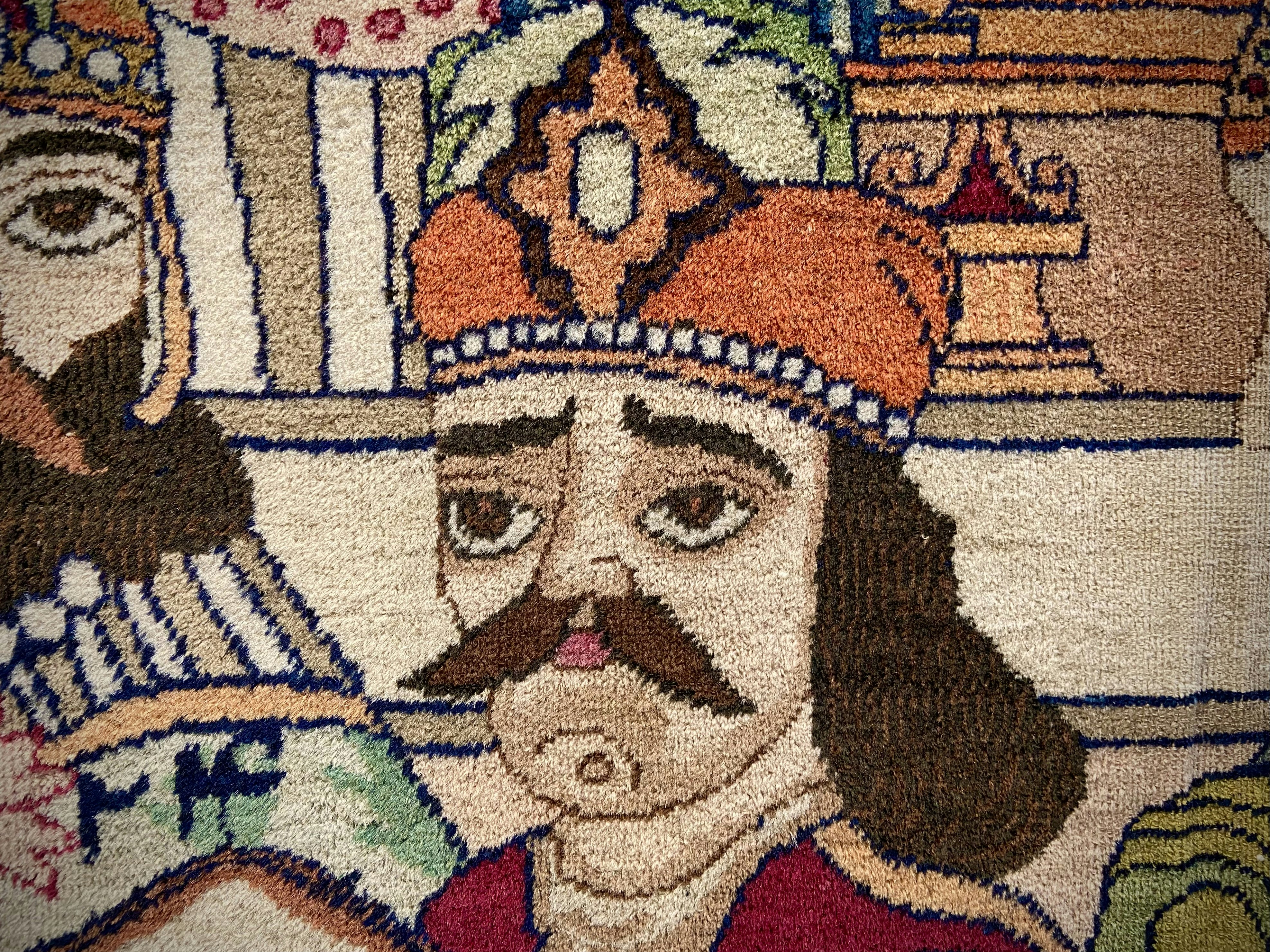 A rug with faces of people.
