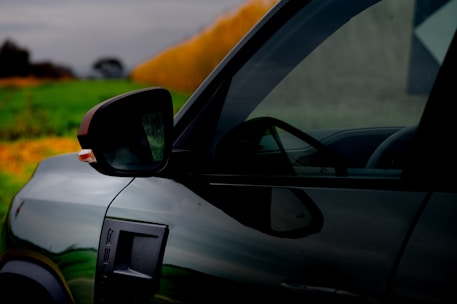 A dark car is seen outdoors.