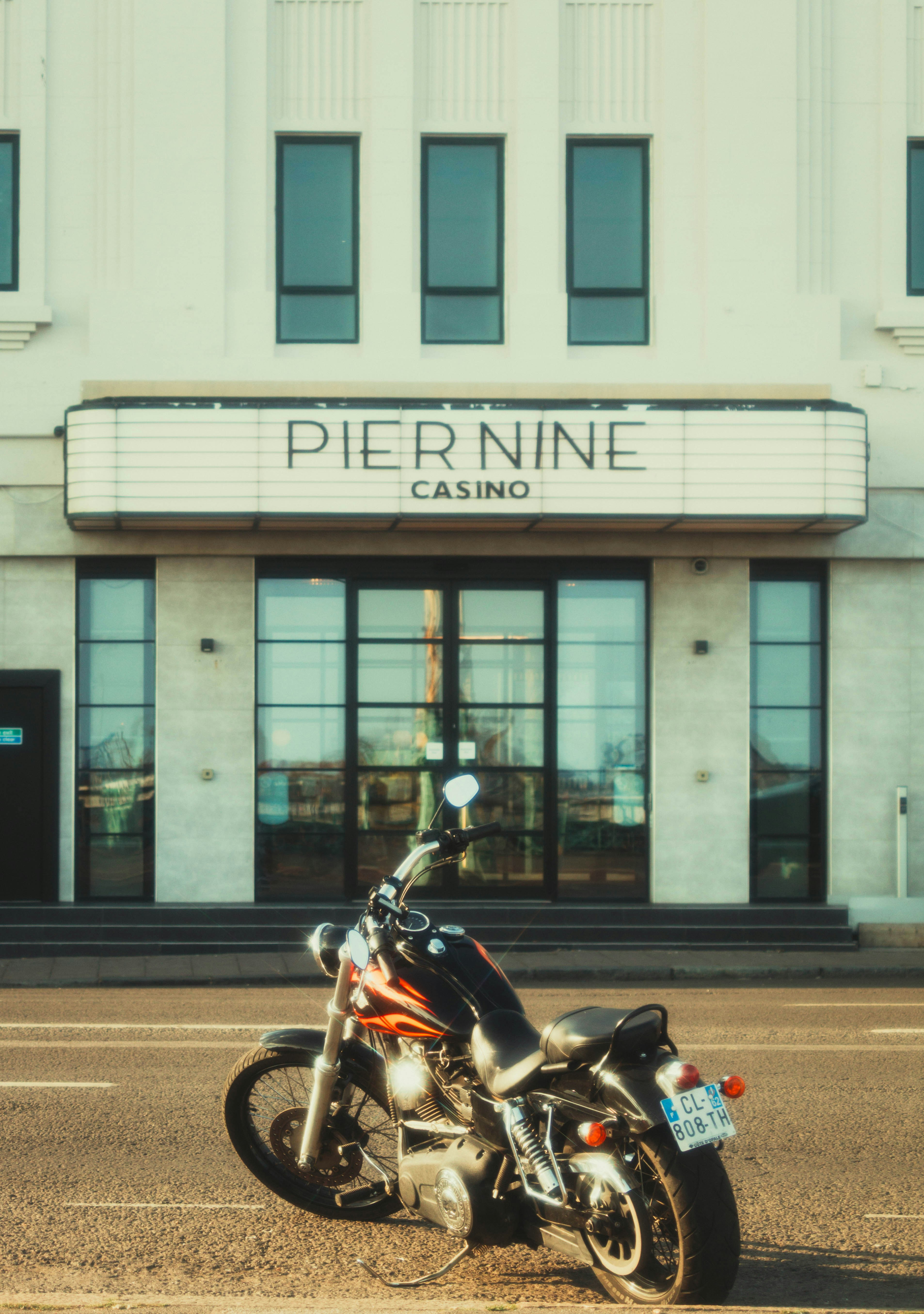 A motorcycle parks in front of the casino.