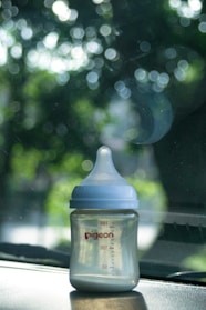 A baby bottle sits inside a car.