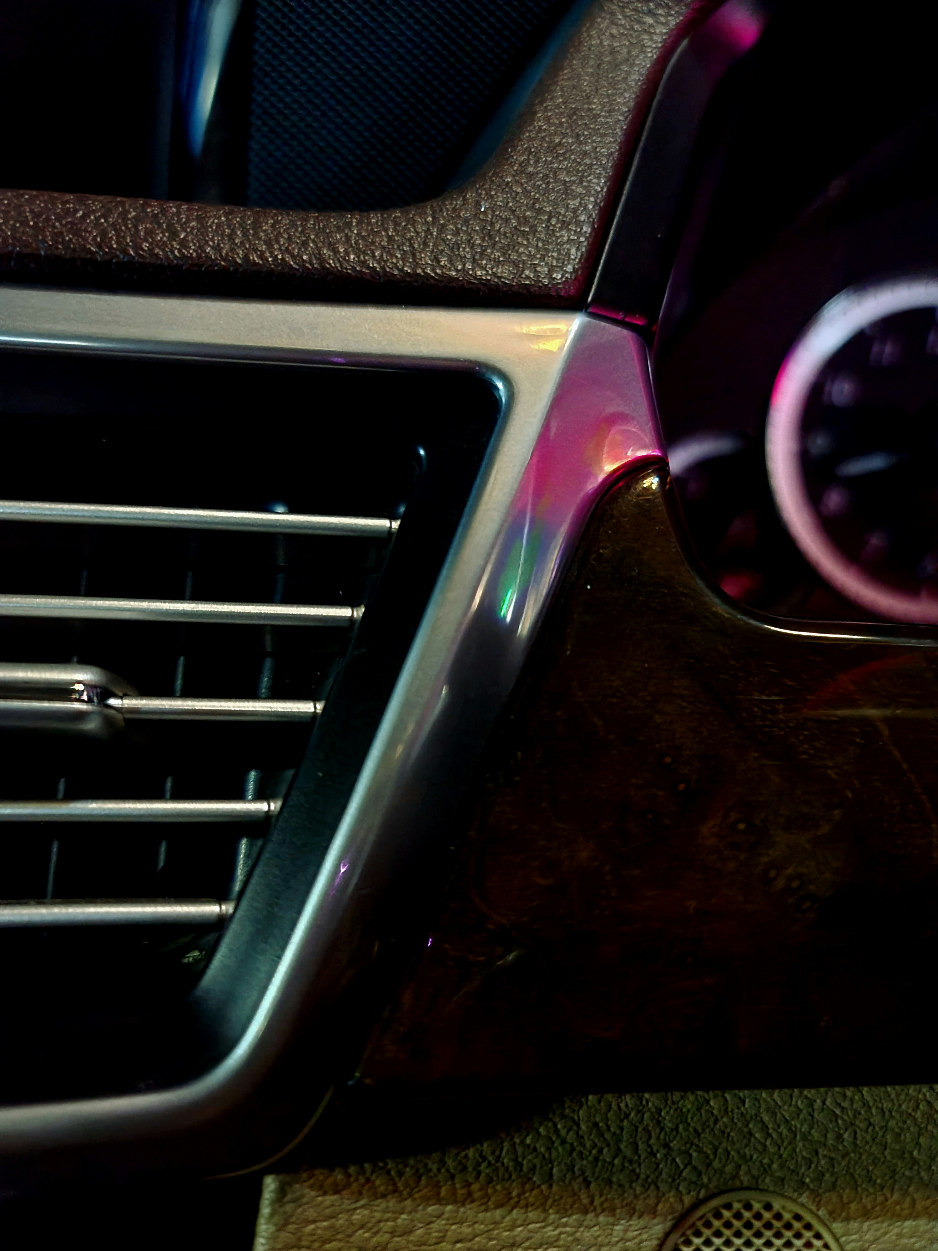 Car's interior, focusing on the dashboard's air vent.