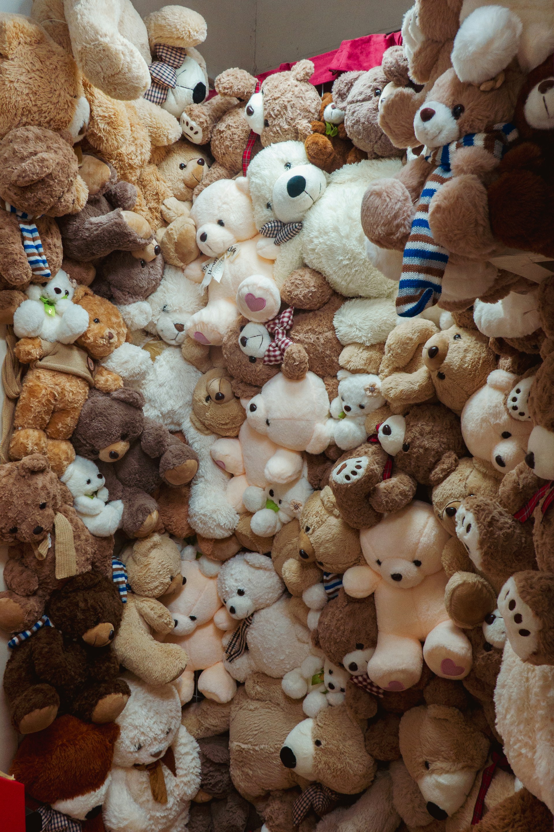 A wall is covered with many teddy bears.