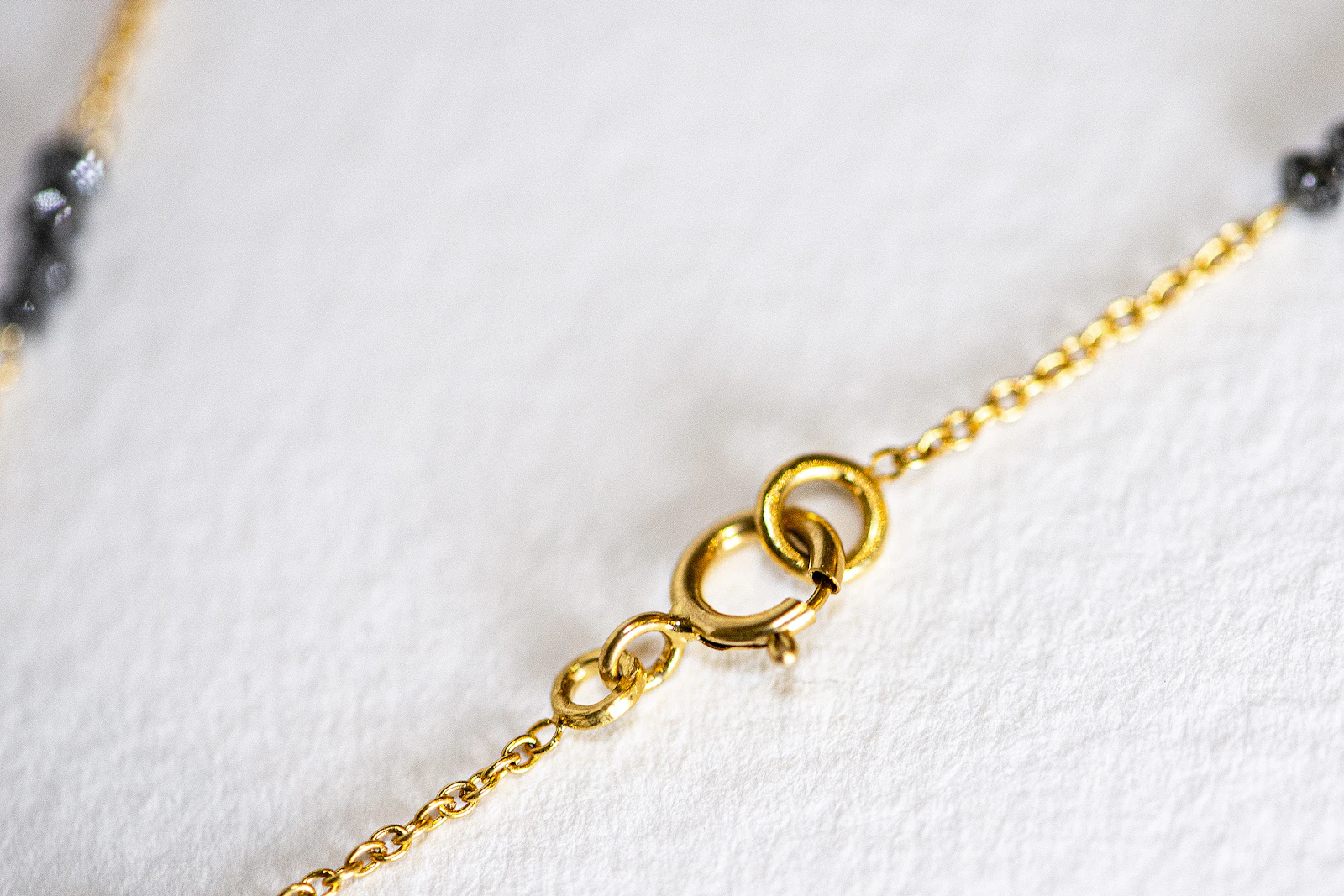 Macro detail of a gold necklace clasp