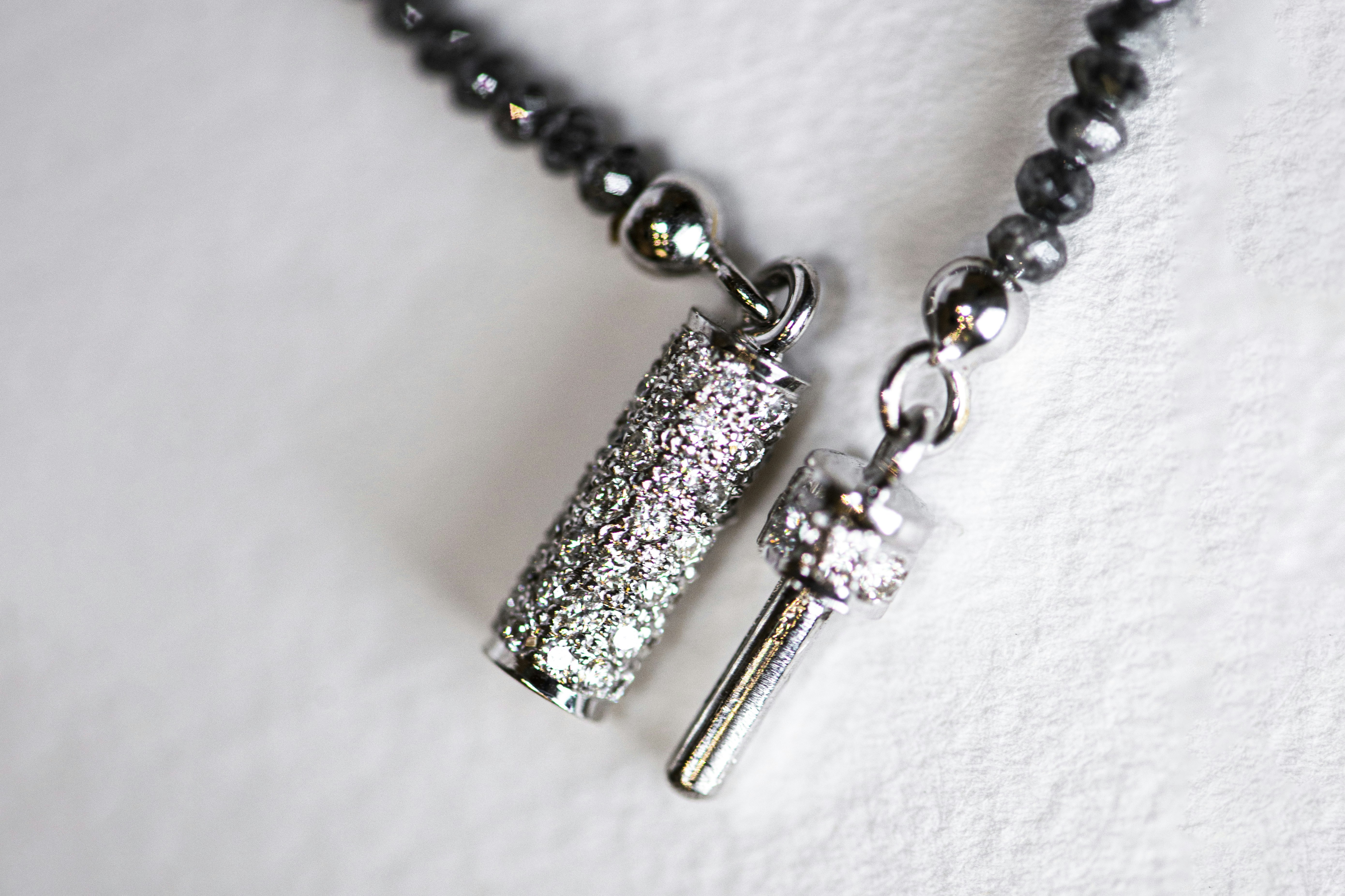 Diamond necklace clasp and details close-up.