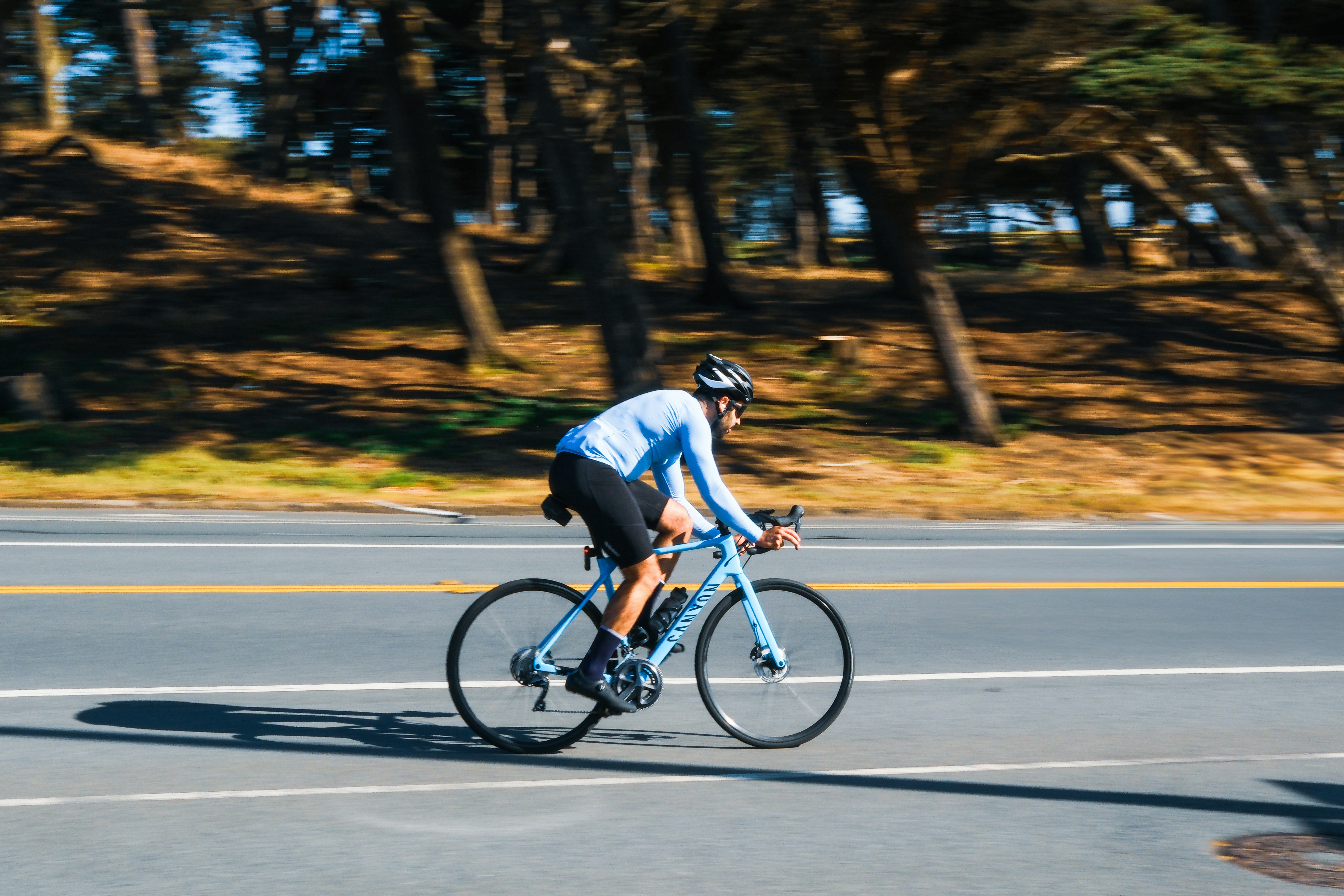 A cyclist rides their bike down a road.