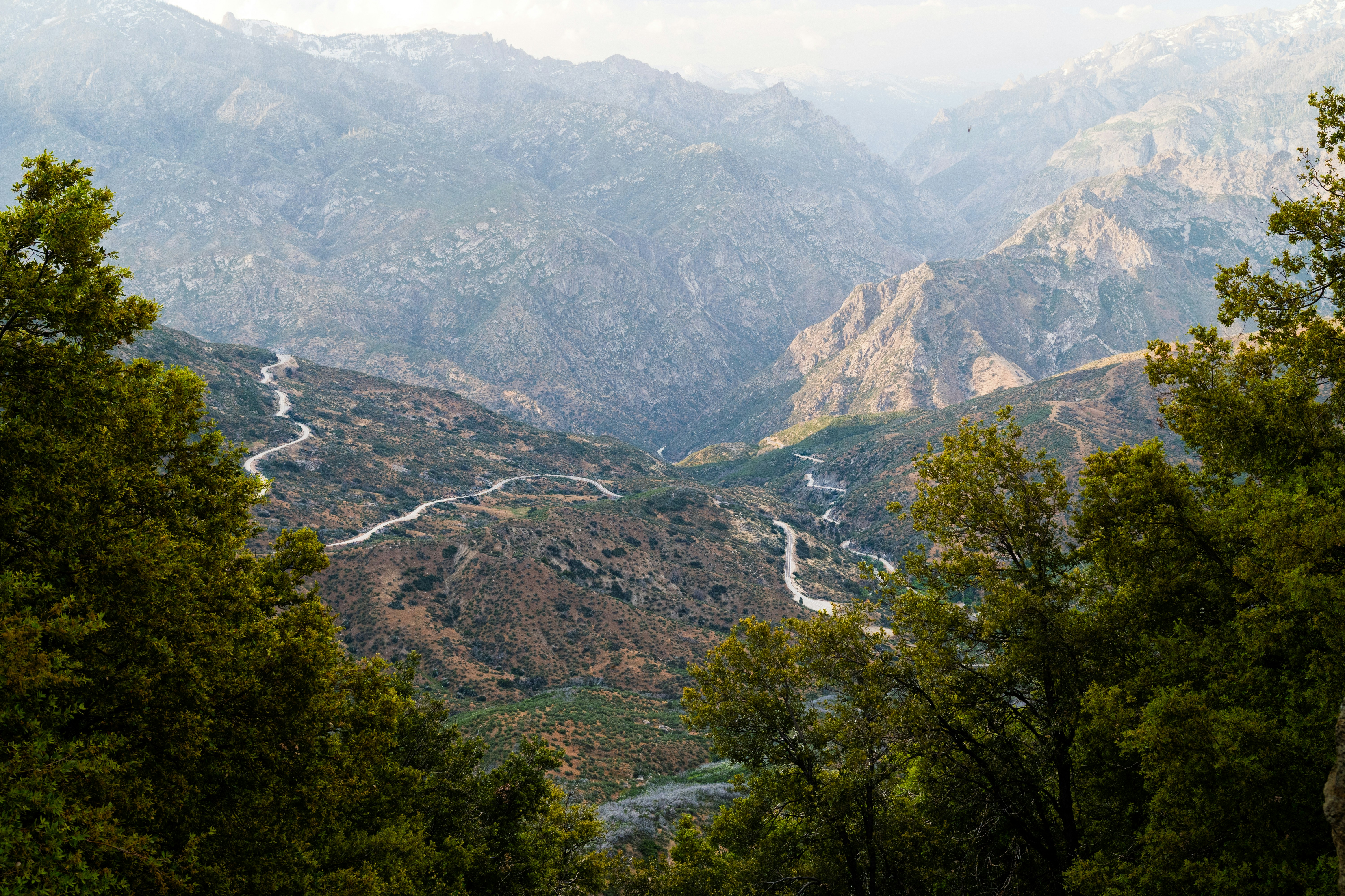 Winding road through majestic, mountainous terrain.