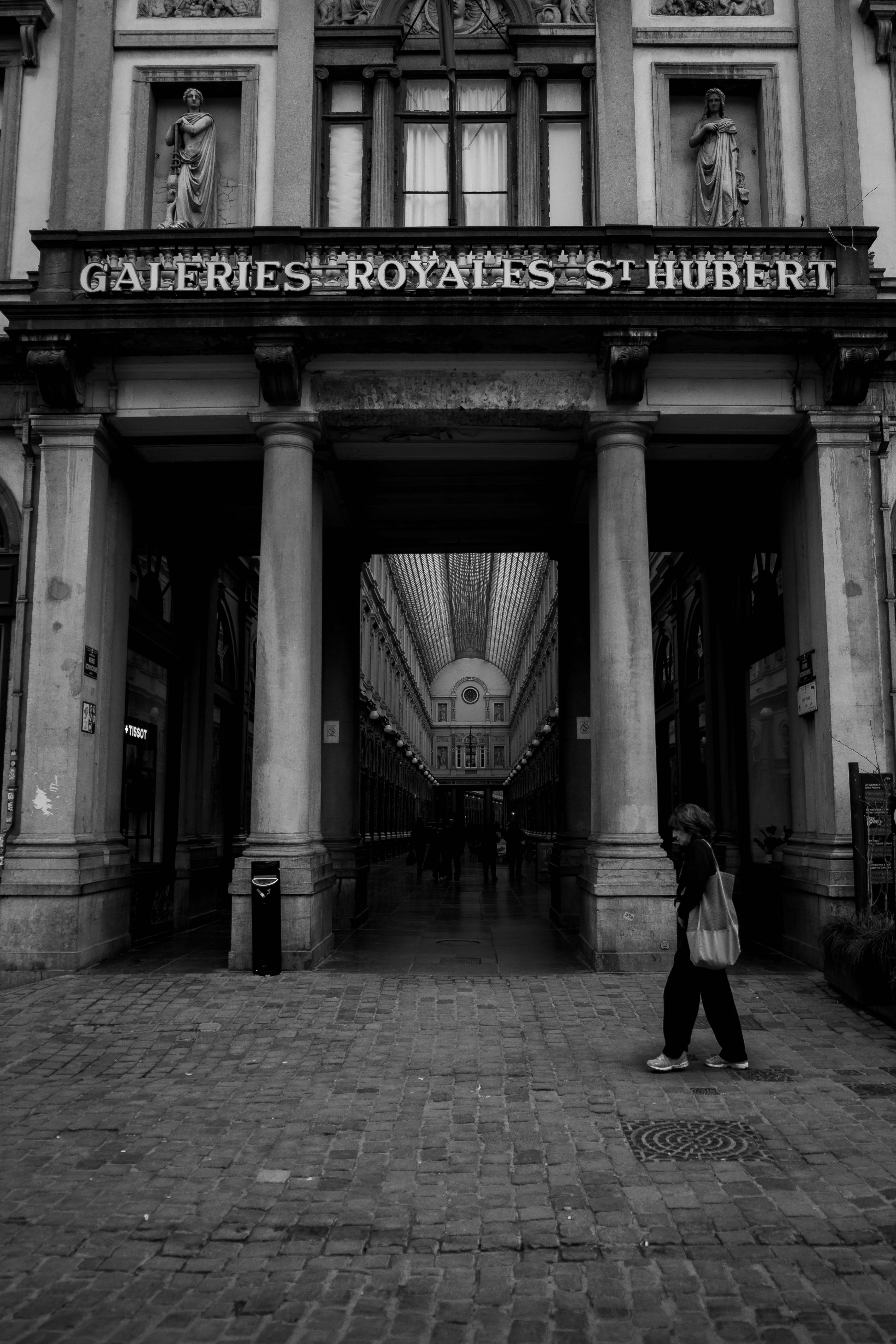A person walks through the historic galeries royales.