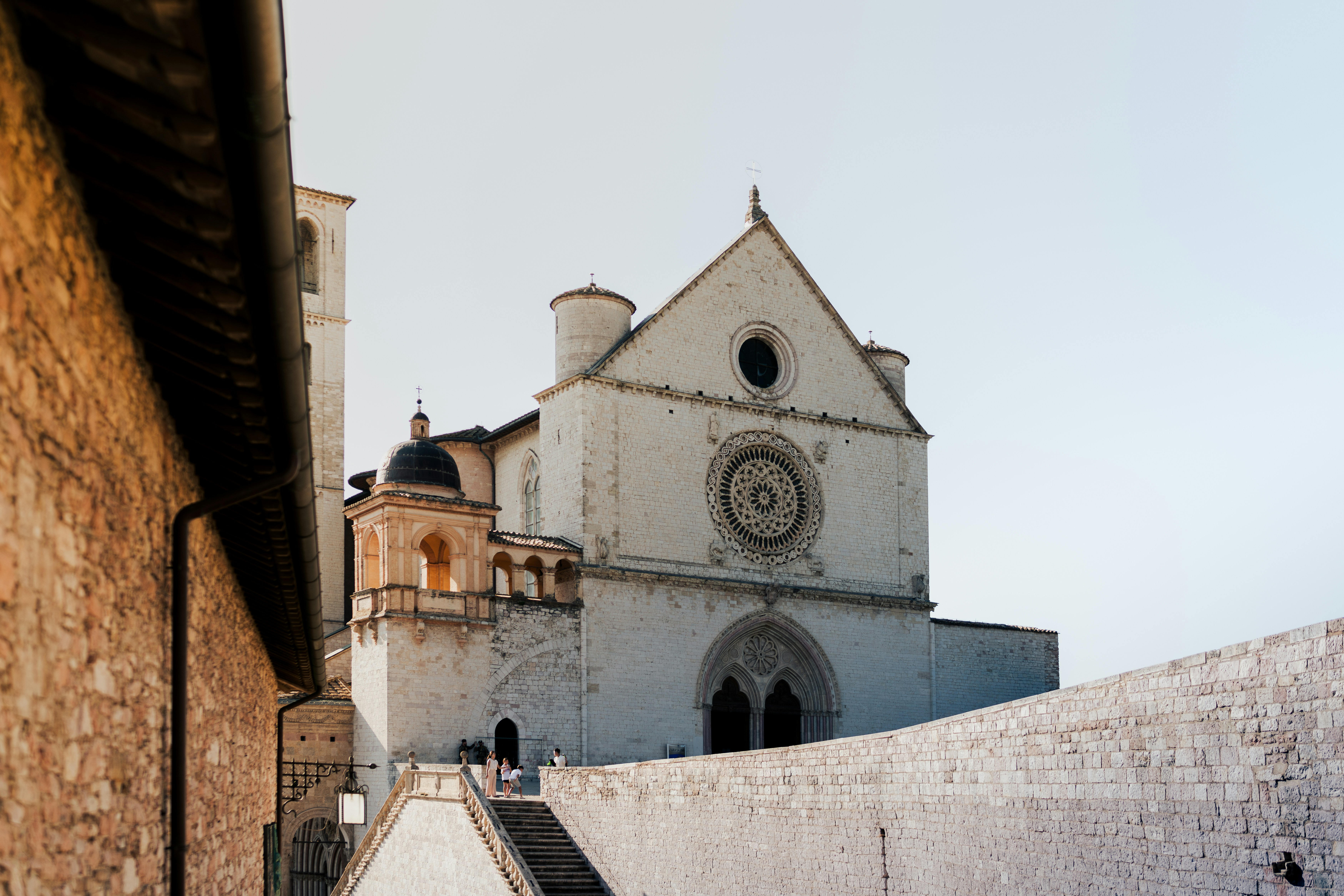 A beautiful italian church stands tall in the sunlight.