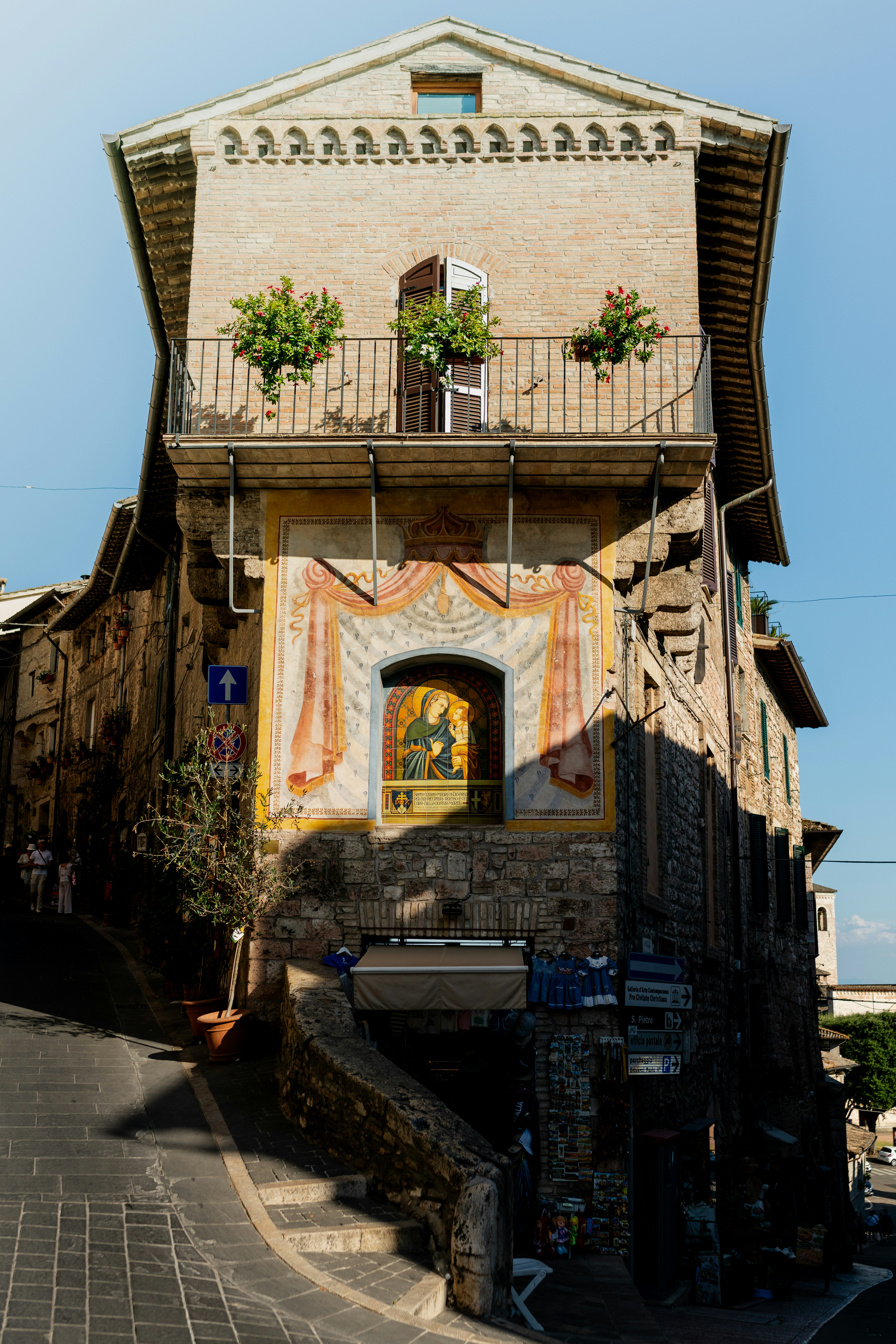 A tall building with painted artwork and balcony.