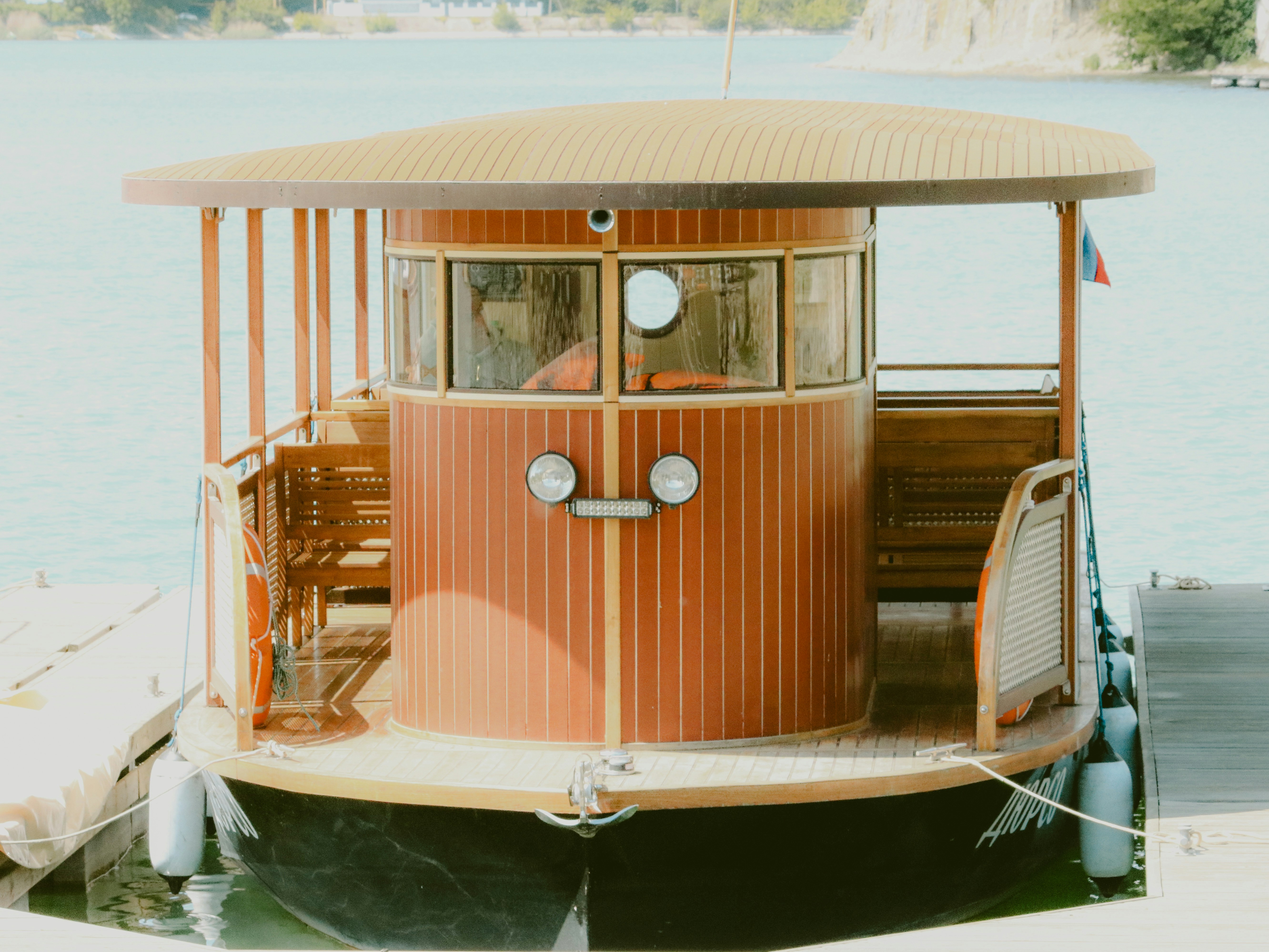A wooden boat is docked at the pier.