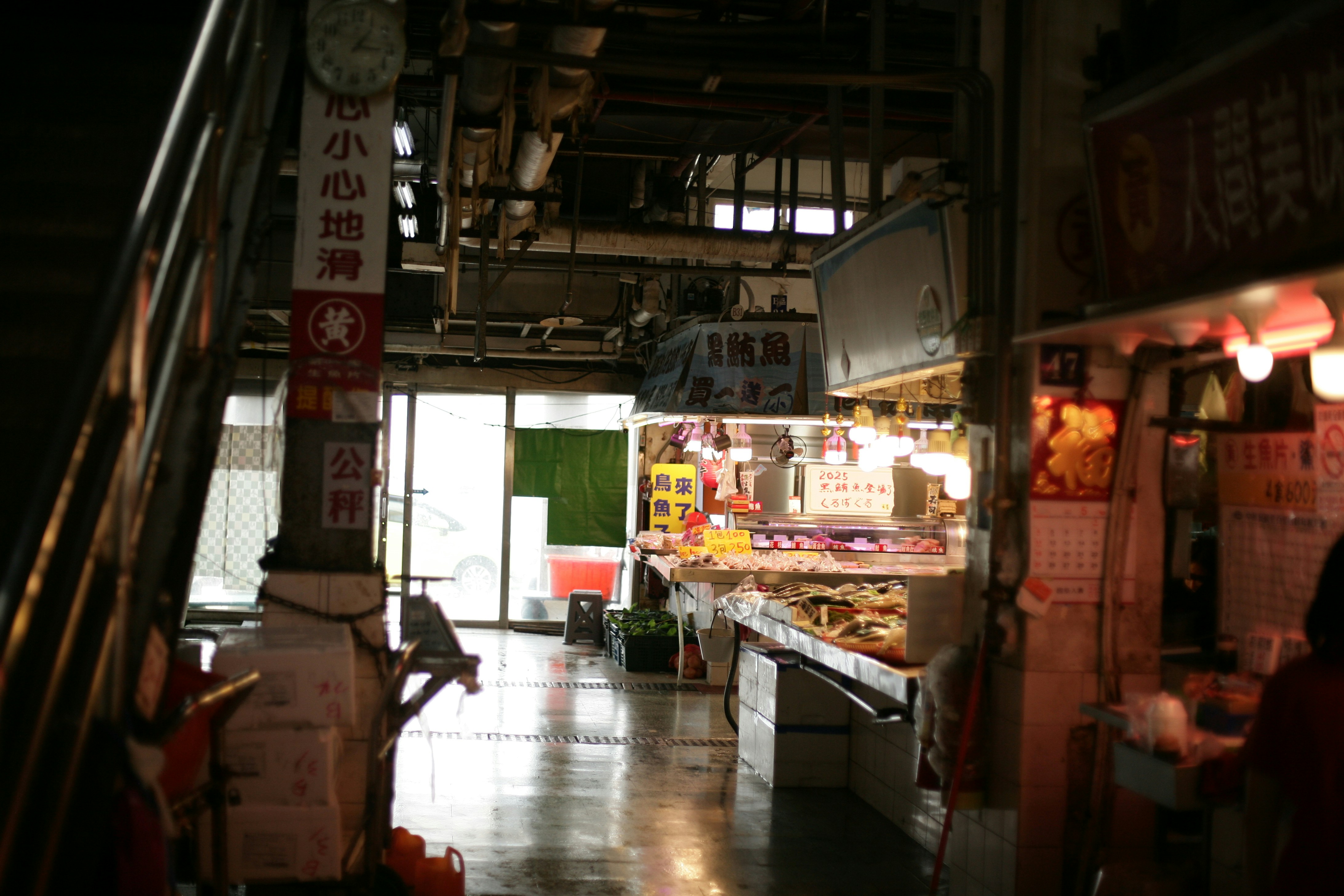 A dimly lit alleyway with shops and stairs