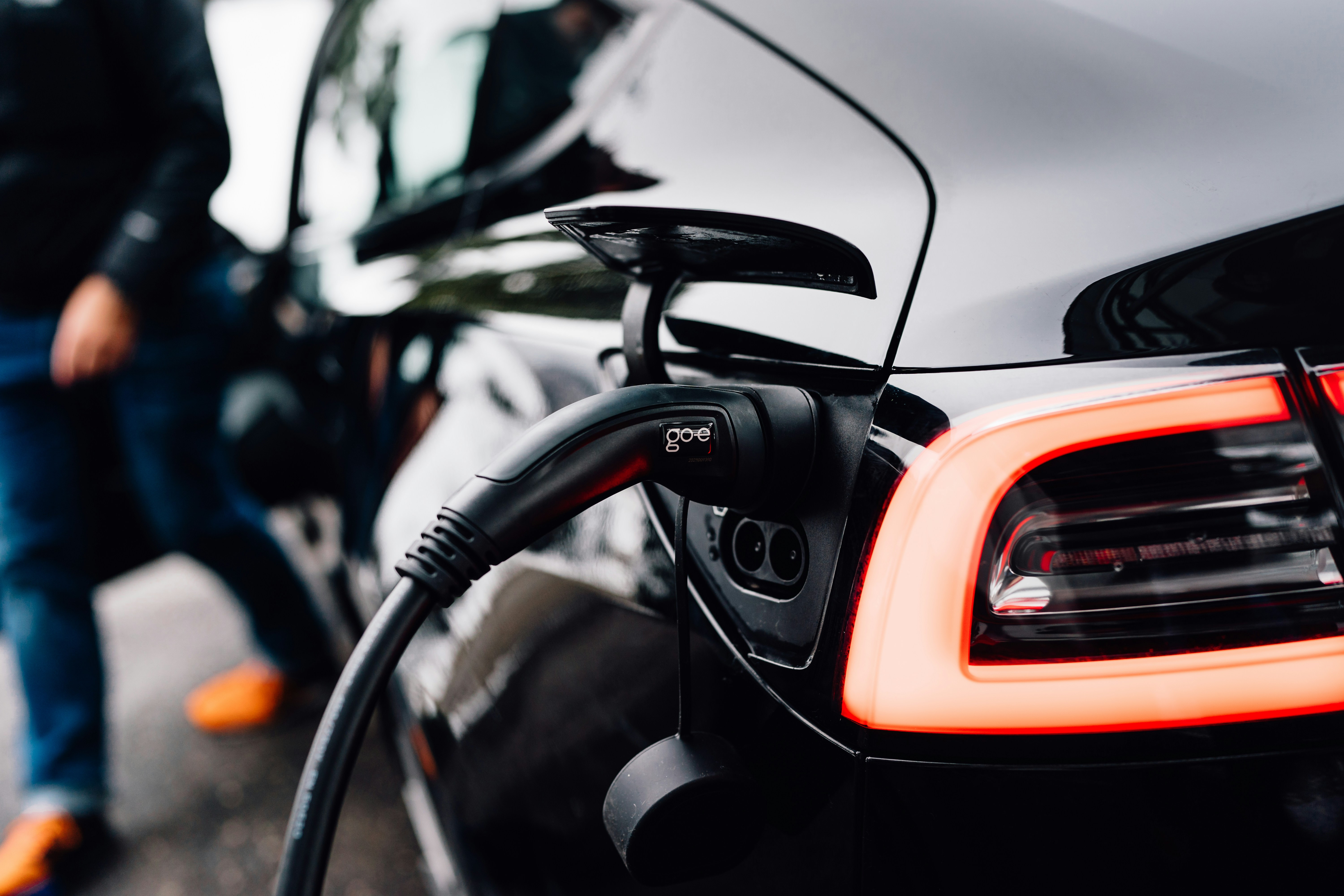 Illustration comparing cost of electricity and gasoline for fueling a car