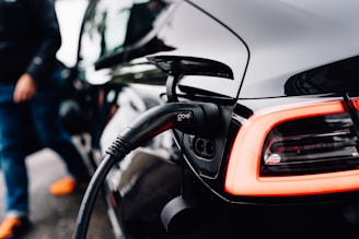 An electric car is charging at a station.