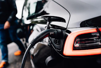 An electric car is charging at a station.