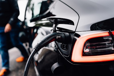 An electric car is charging at a station.