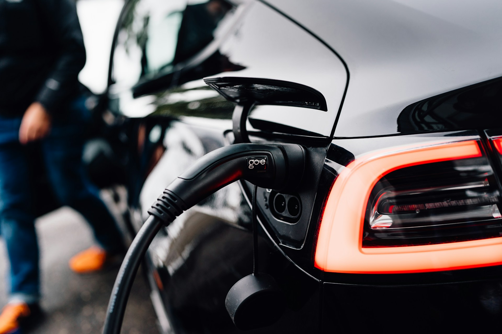An electric car is charging at a station.