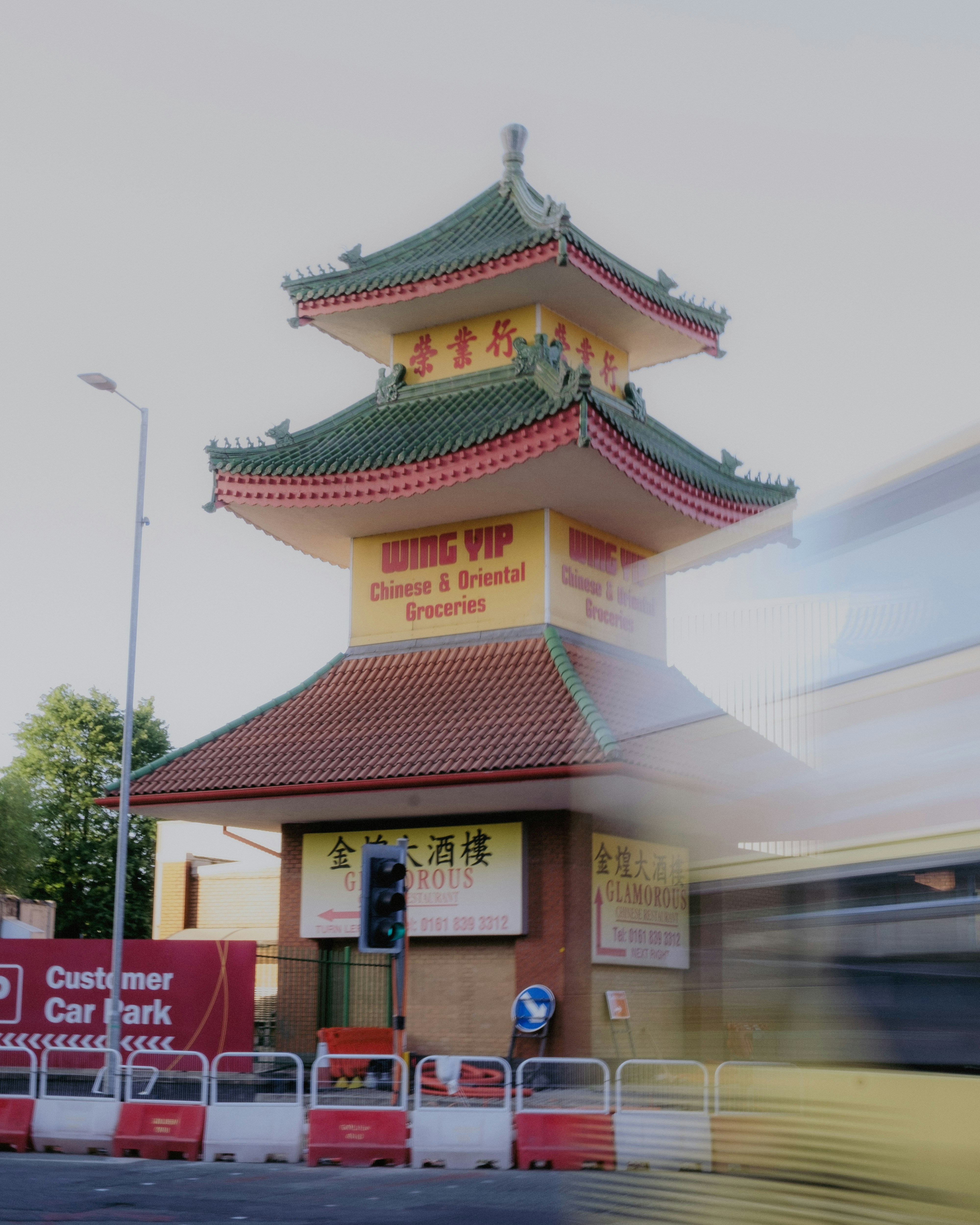 A chinese pagoda stands in a bustling city.