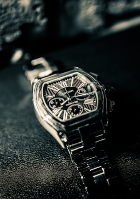 Cartier Roadster chronograph watch on dark textured surface for auction