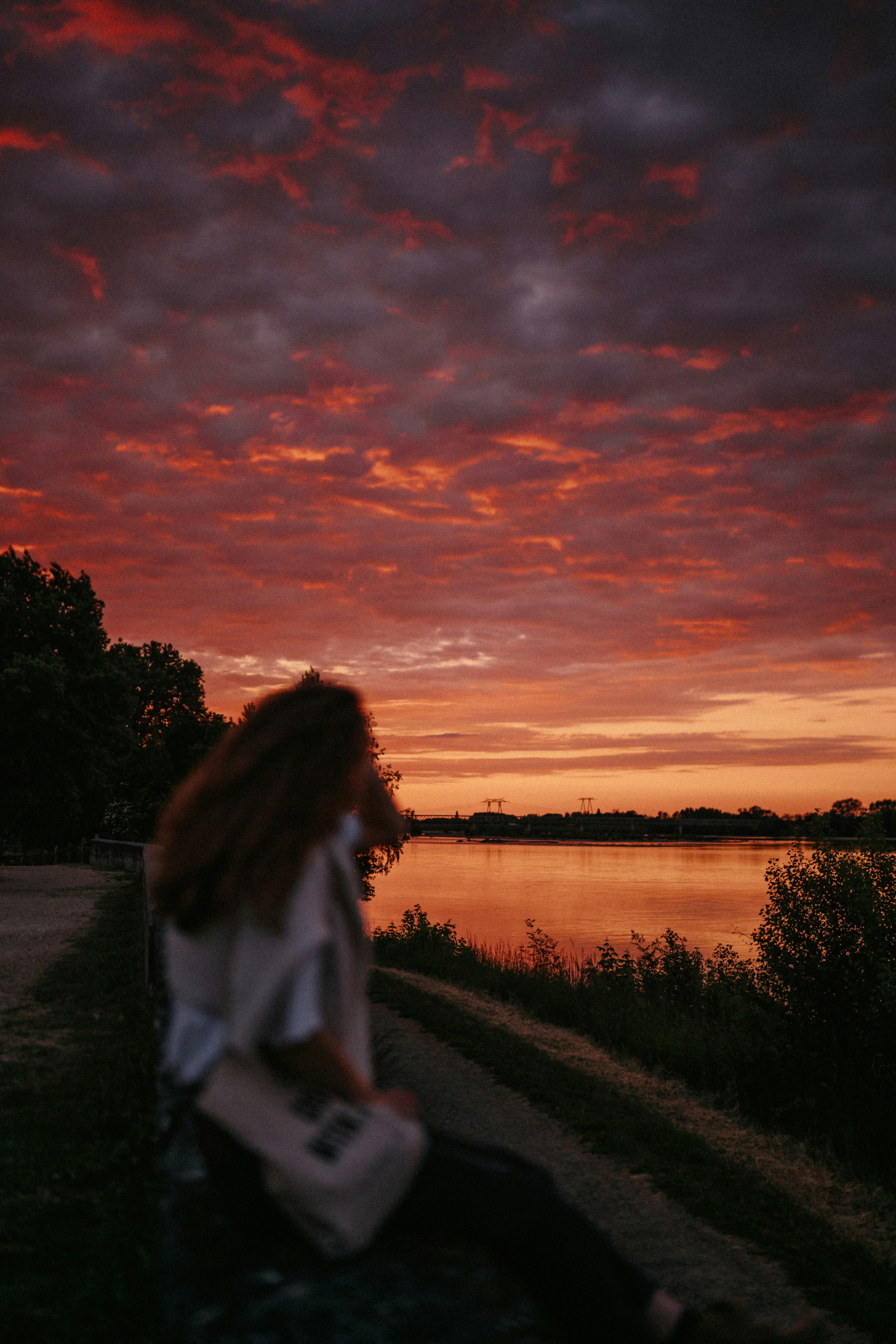 A person watches the fiery sunset.