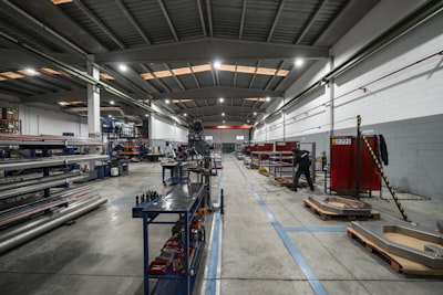 Workers and heavy equipment inside industrial plant