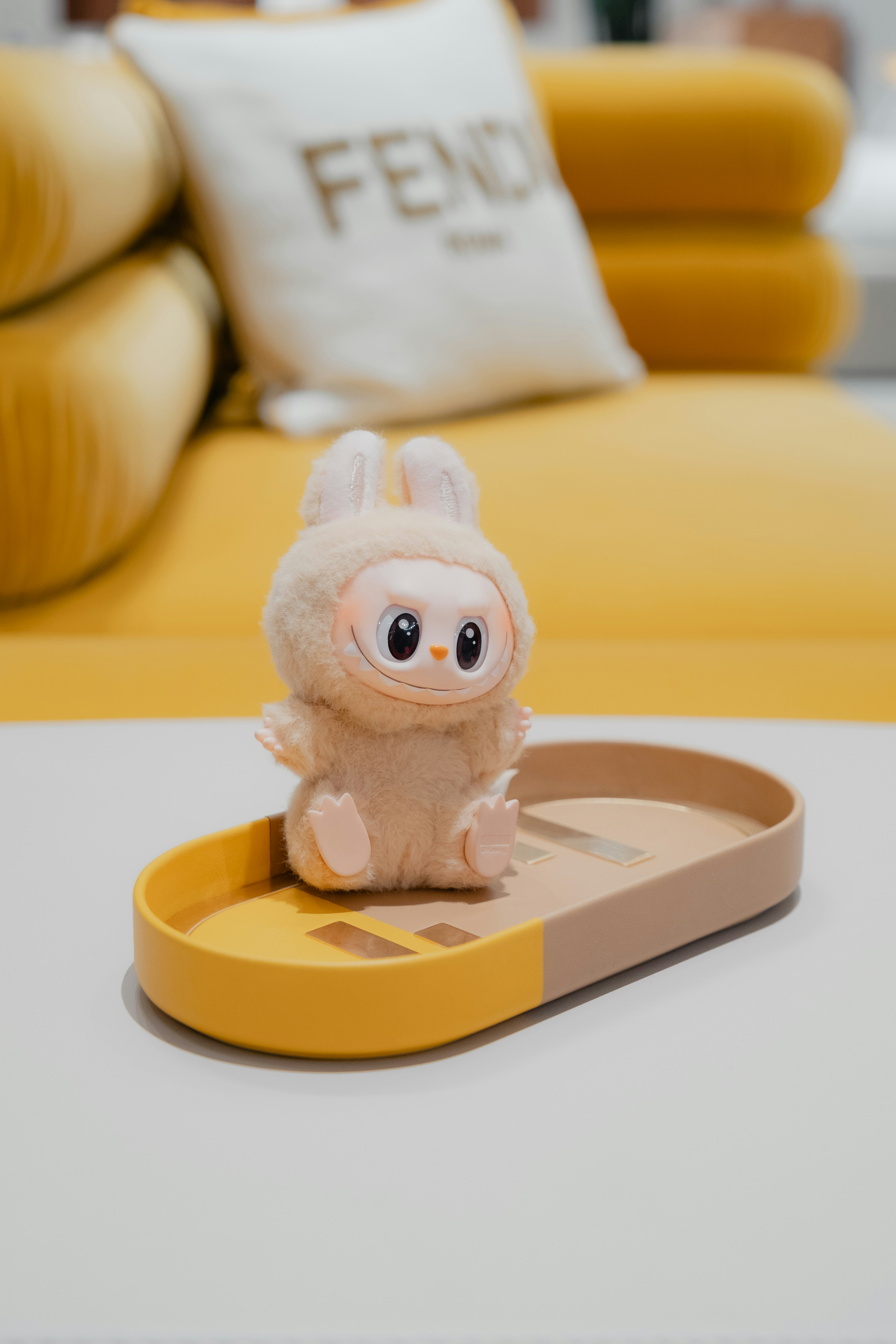 A cute bunny plush toy on a tray.