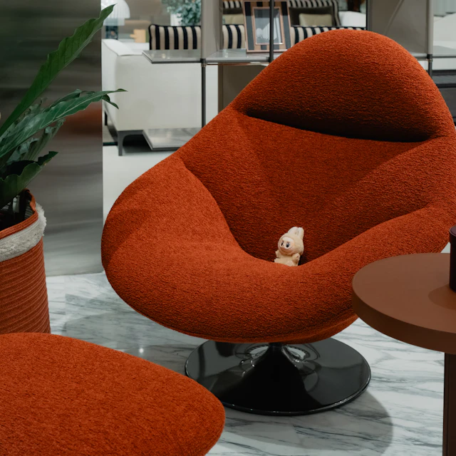 A cozy upholstered lounge chair with a matching ottoman