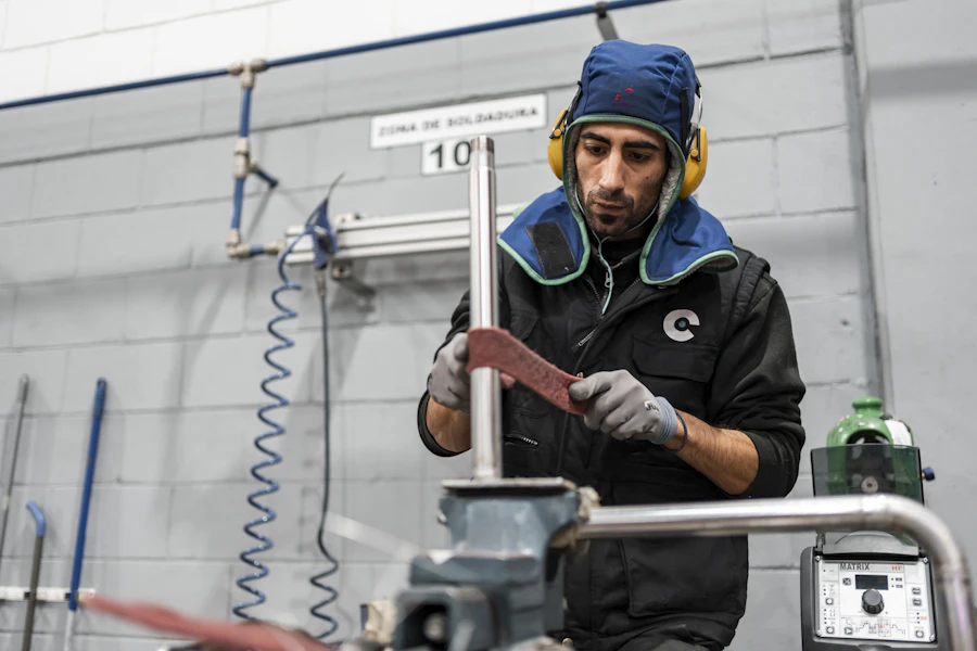 Technician performing maintenance work in an HVAC workshop