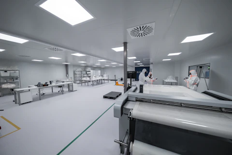Workers in aerospace clean room facility
