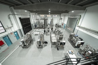 Inside a large industrial factory building.