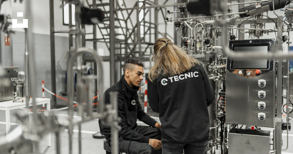 Medical device manufacturing team working in a clean production environment with quality oversight and inspection focus