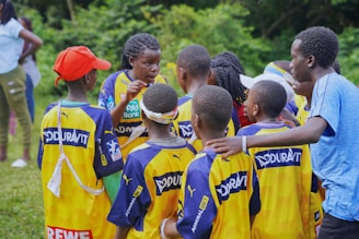 A soccer team huddles together for a pep talk.
