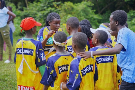 A soccer team huddles together for a pep talk.