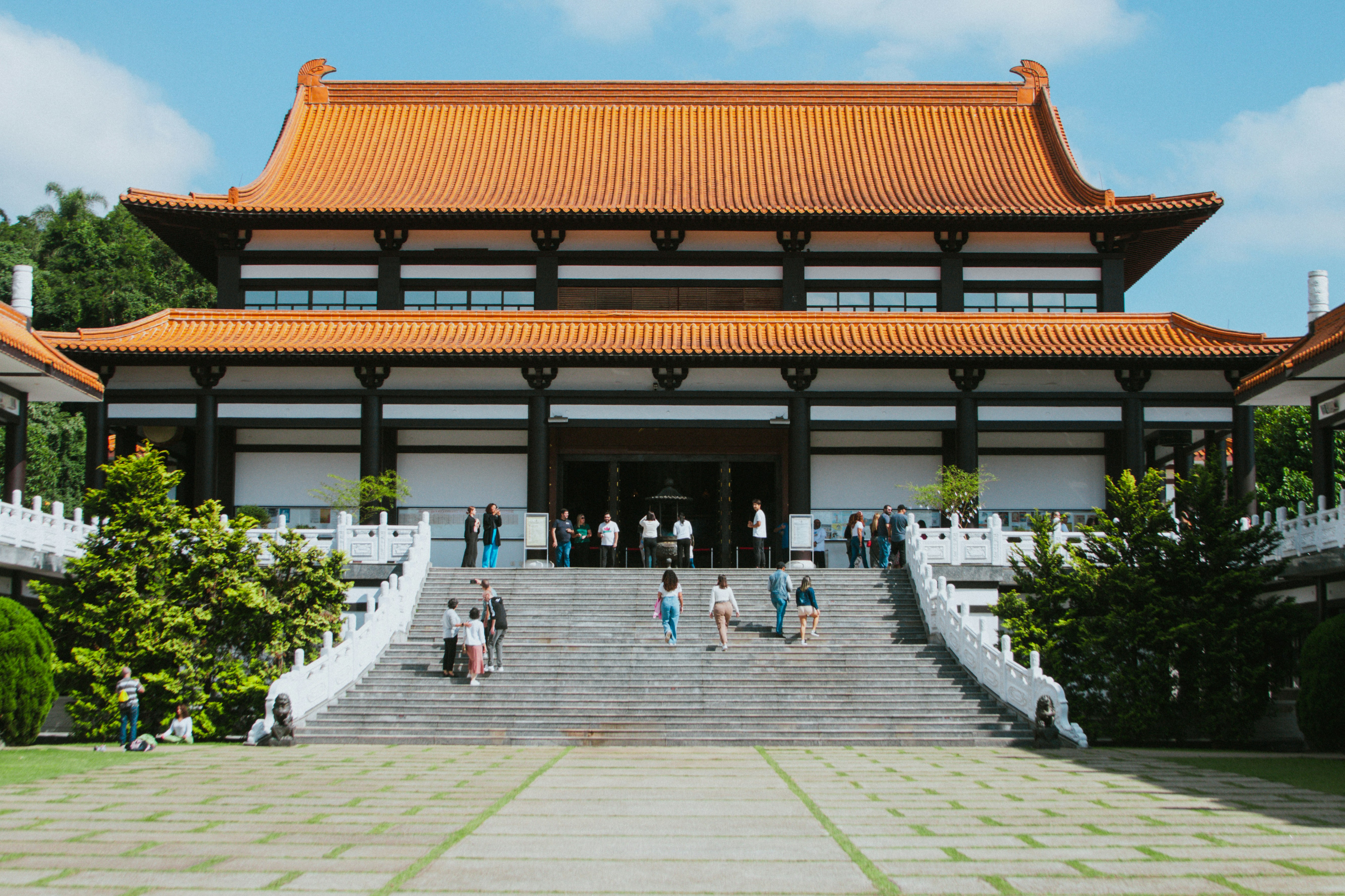 People are walking up the steps of a temple.