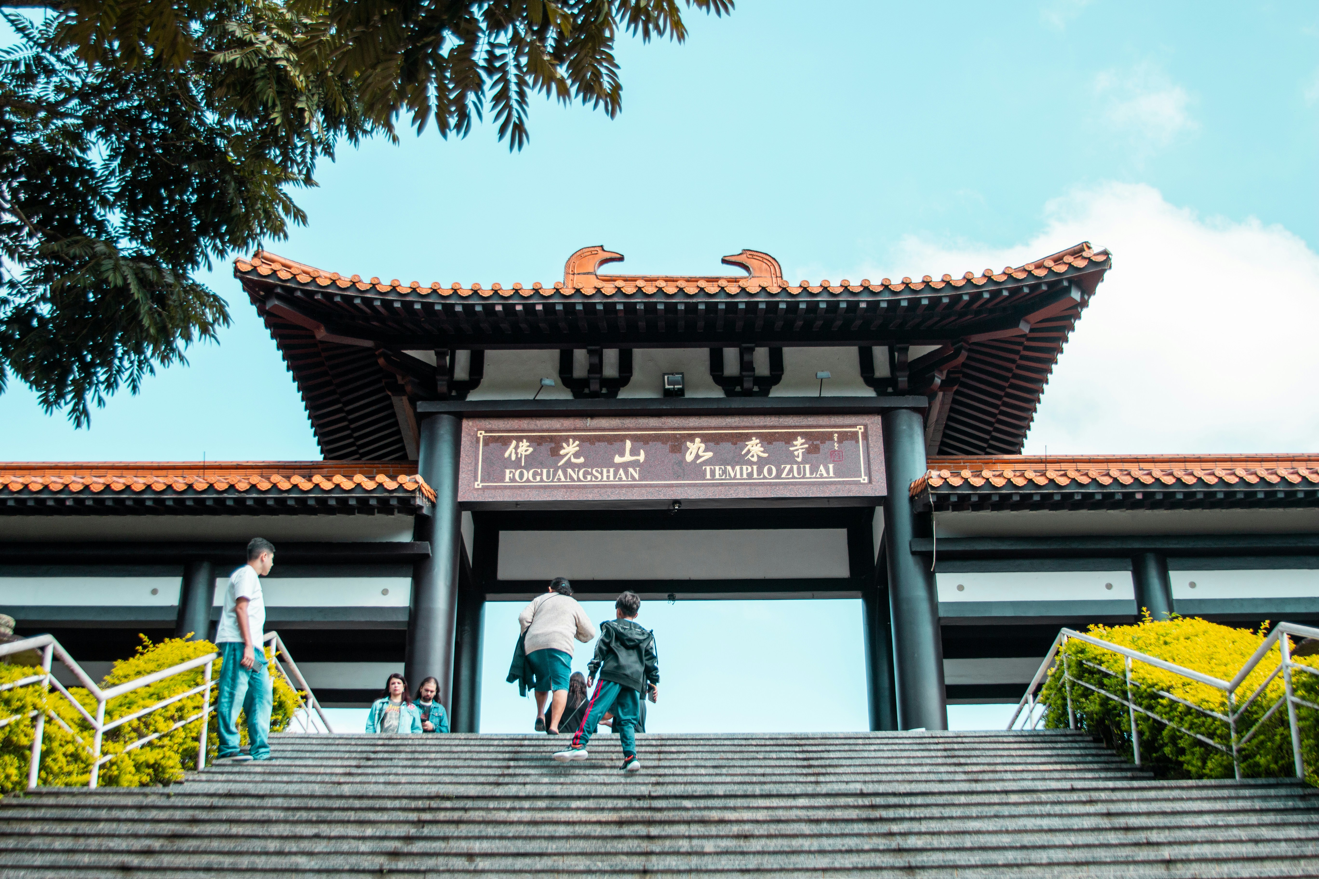 People enter a chinese temple through the gate.
