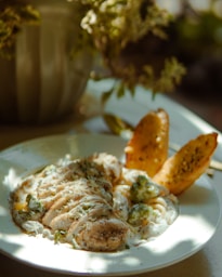 Chicken with a creamy sauce and roasted bread.