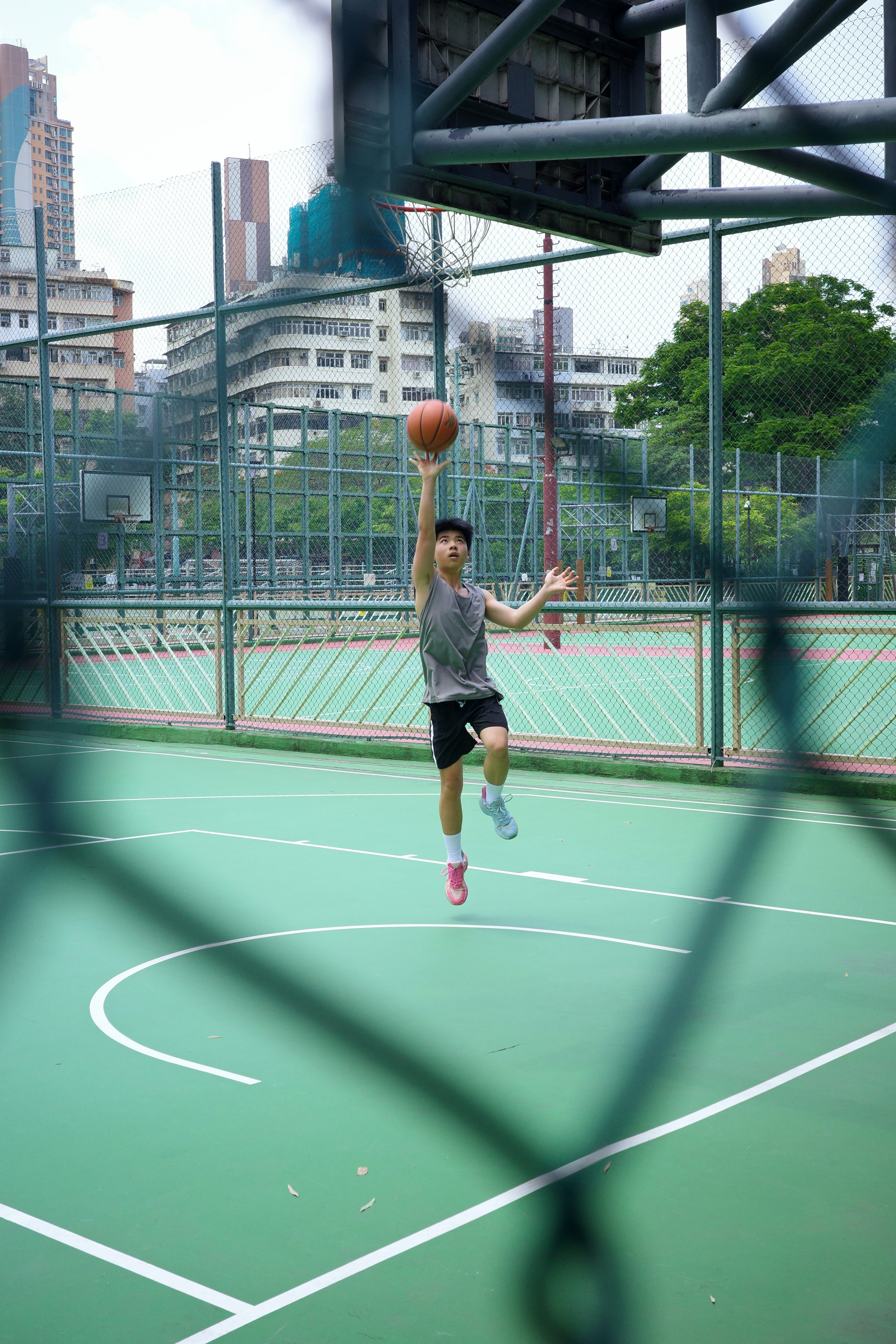 A young man shoots a basketball.
