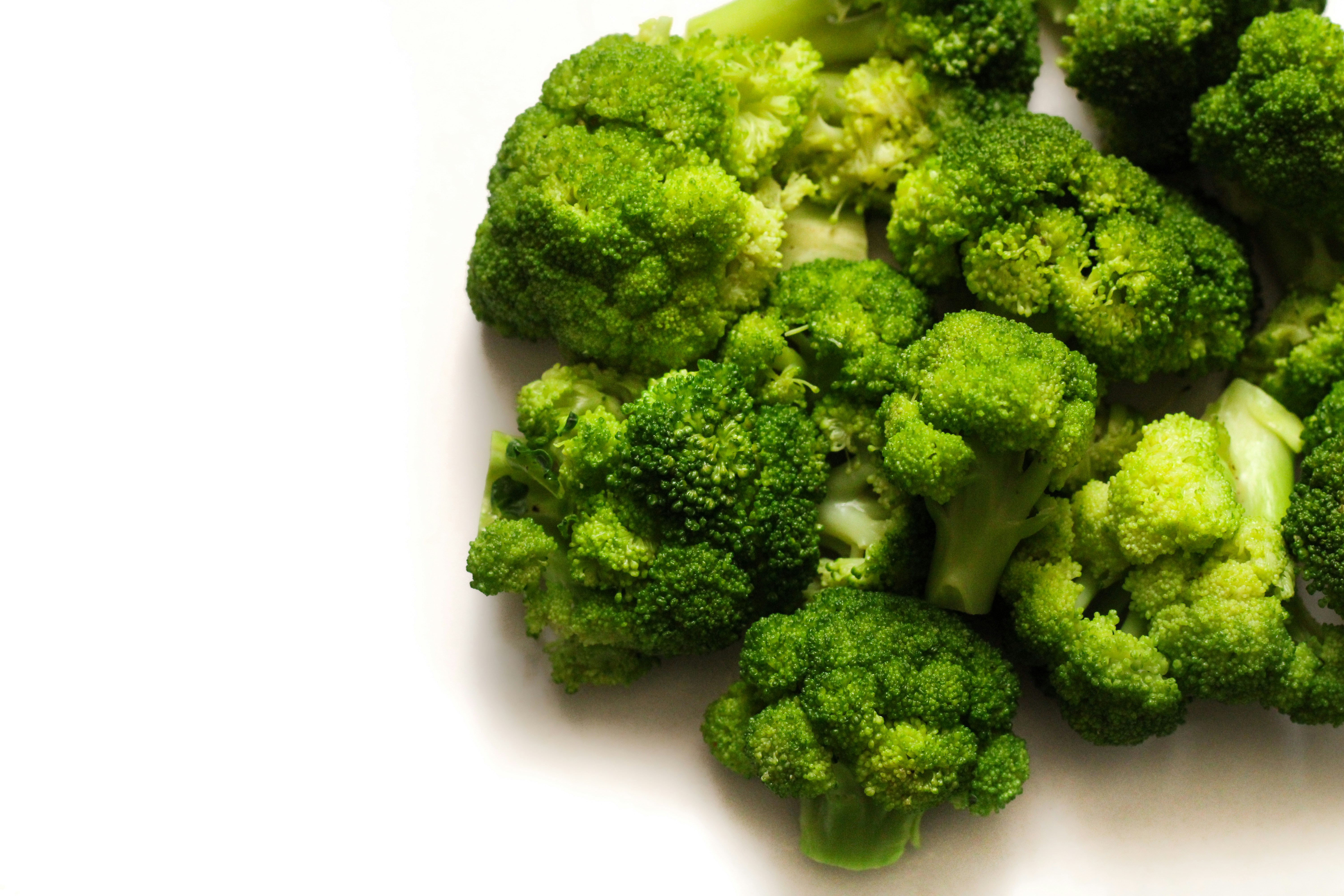 bright green blanched broccoli florets ready for blending - broccoli pesto vegan