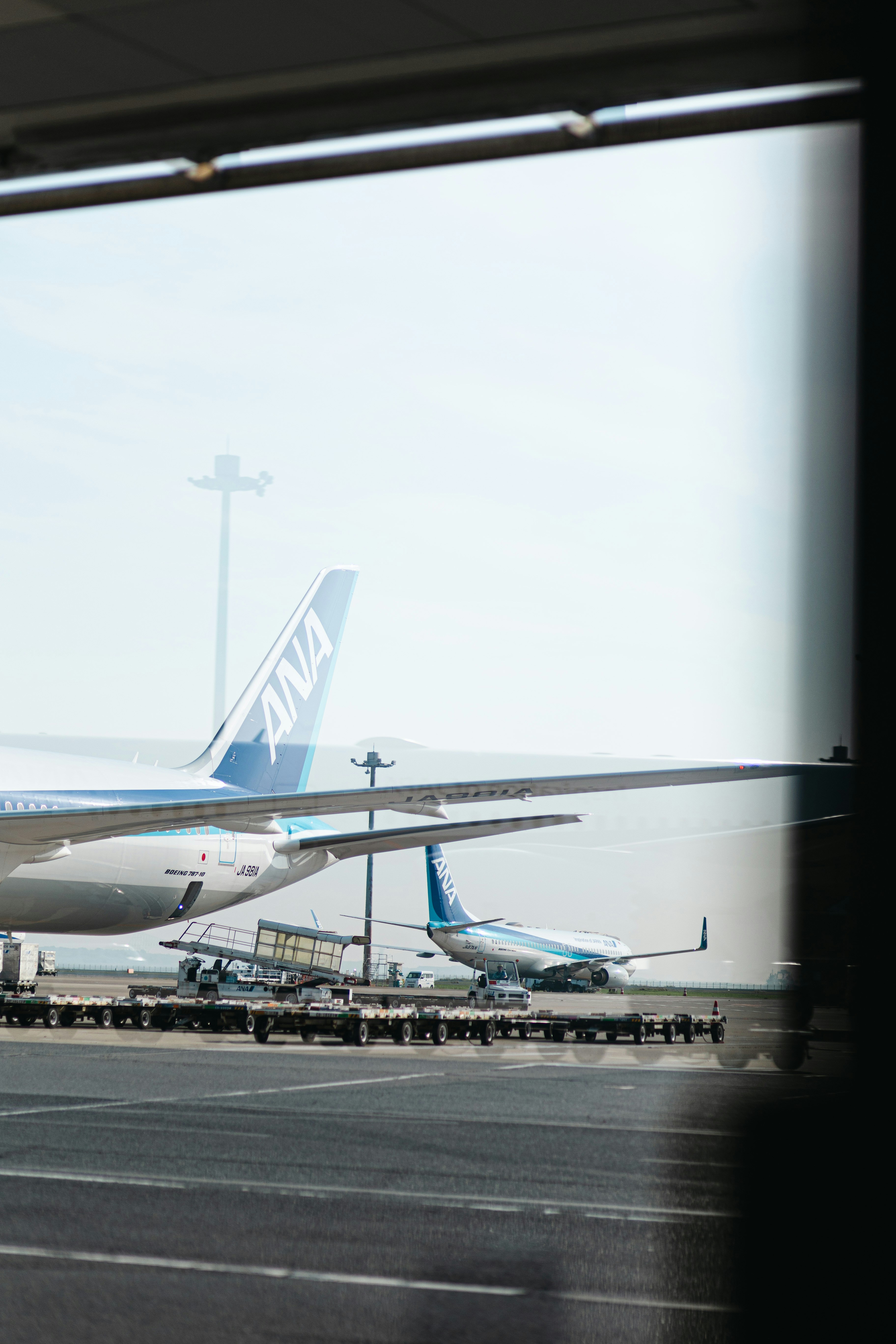 Airplanes sit on the tarmac at the airport.