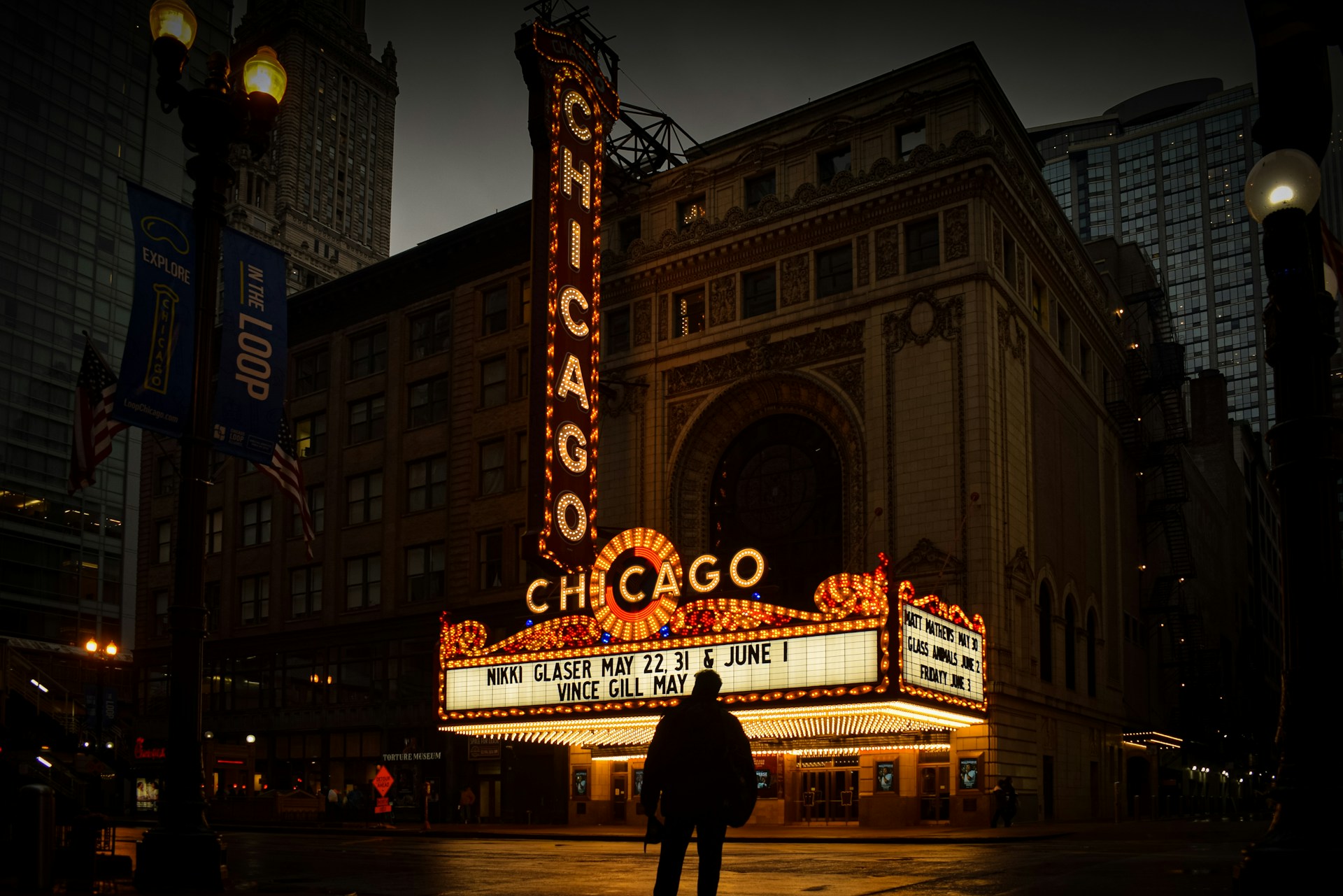 The chicago theatre is illuminated at night.