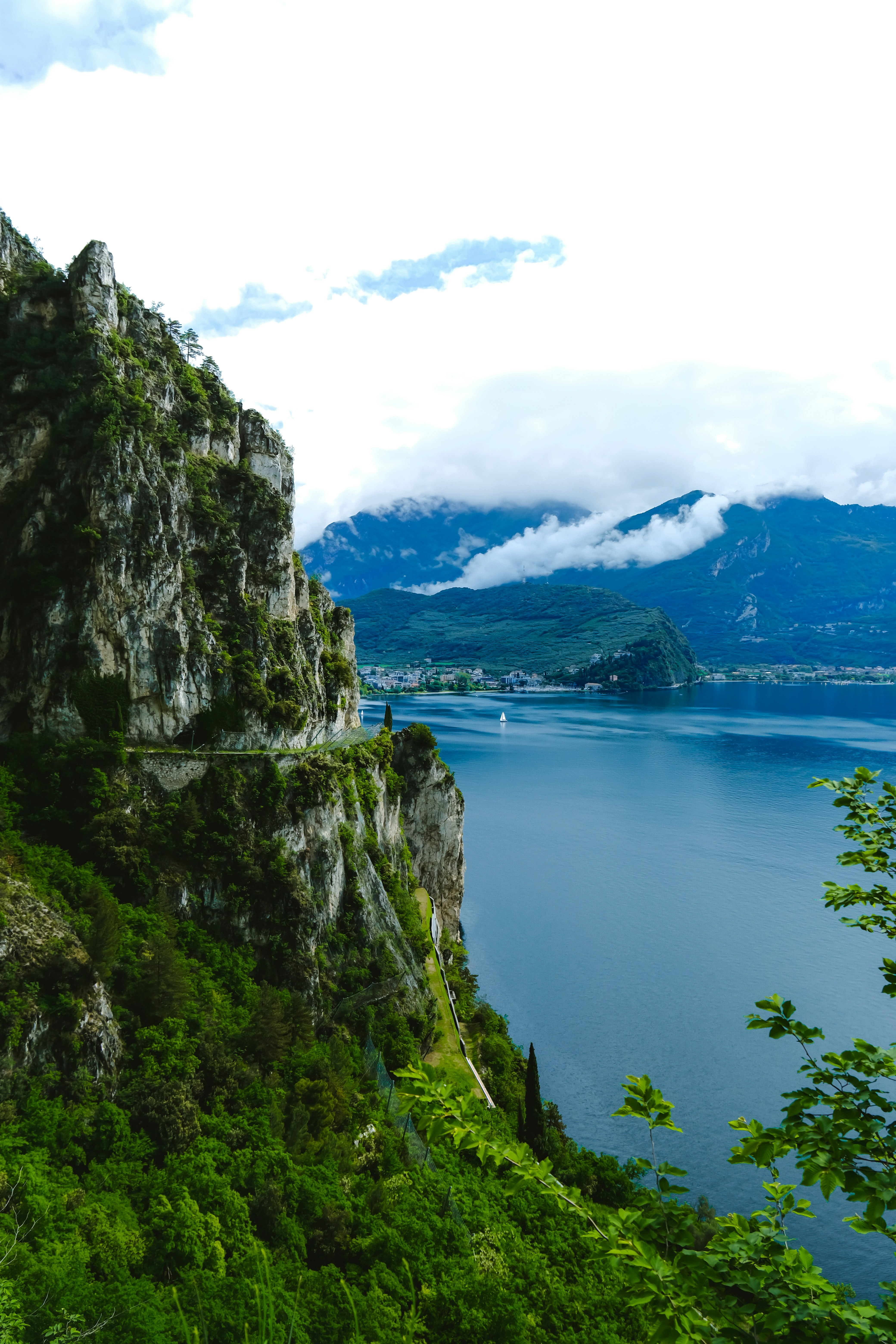 Cliffside with a lake and mountains in the distance.