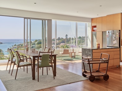 A modern dining room overlooks a beautiful view.