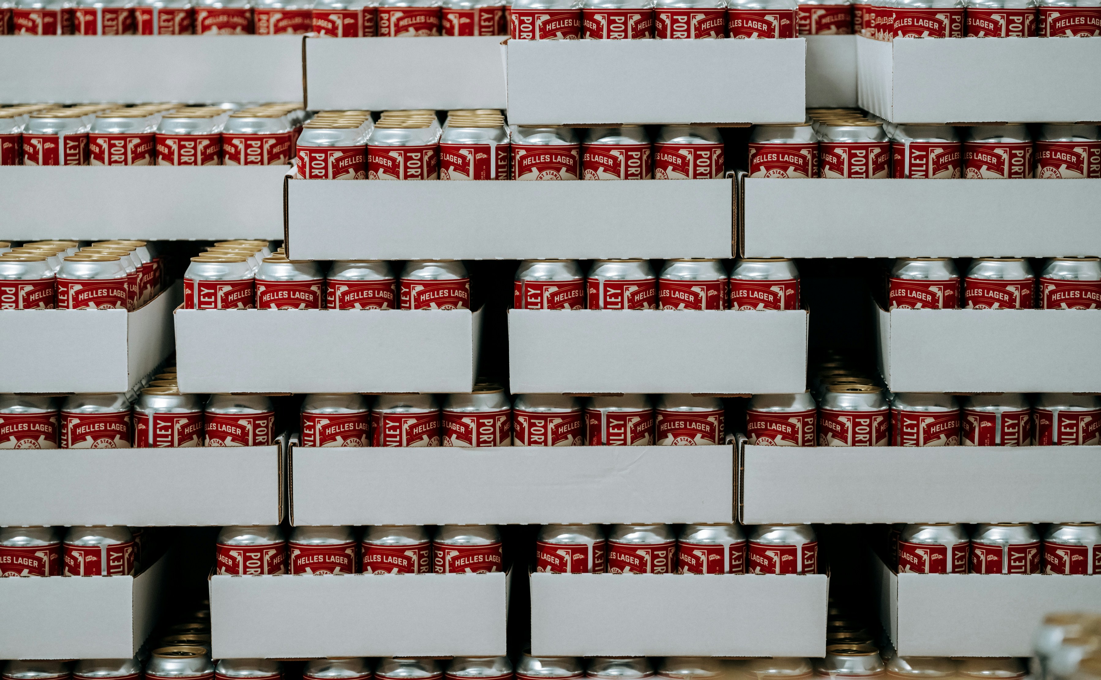 Cases of canned beverages are stacked high.