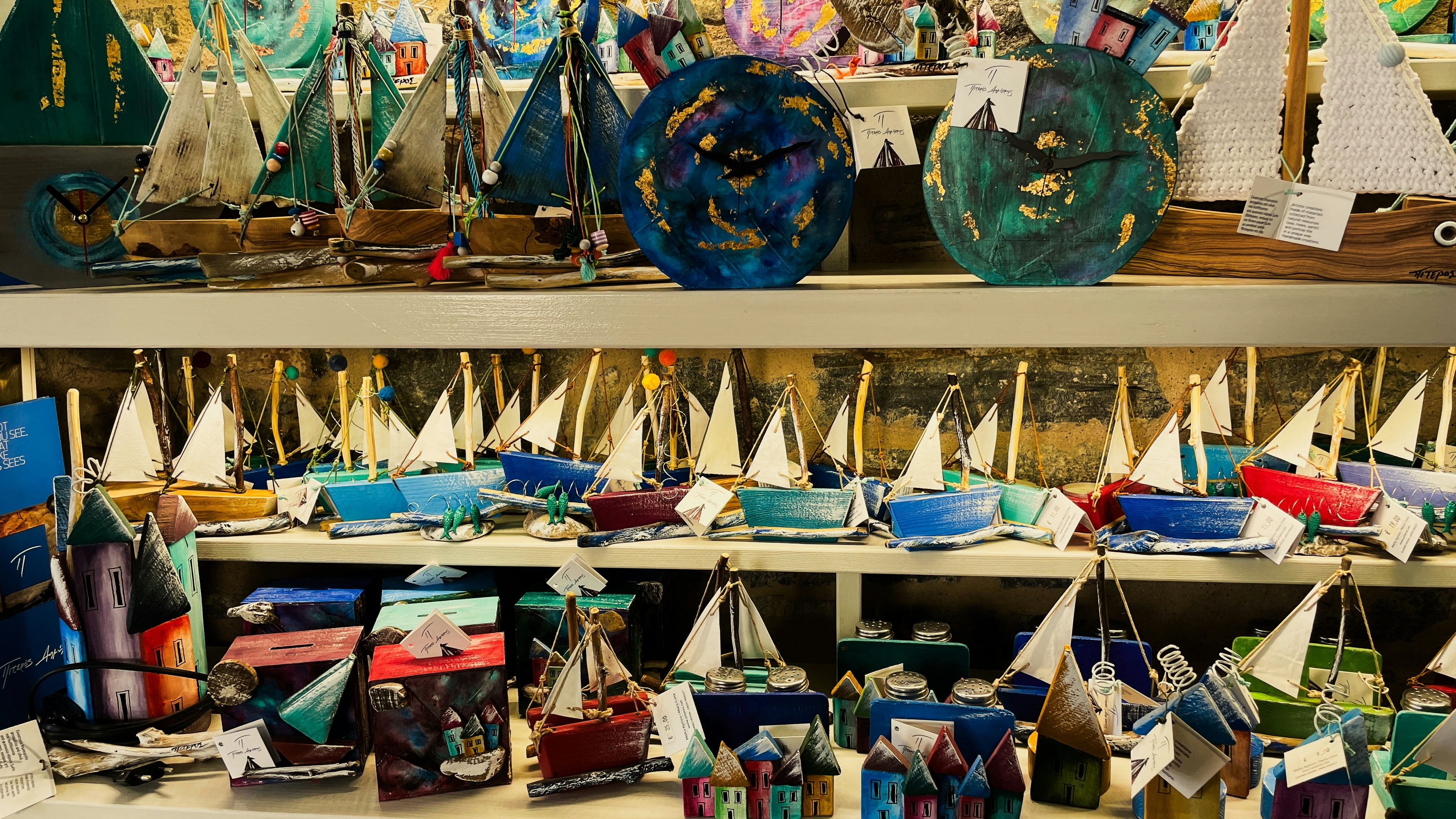 Sailboat souvenirs are displayed on shelves.