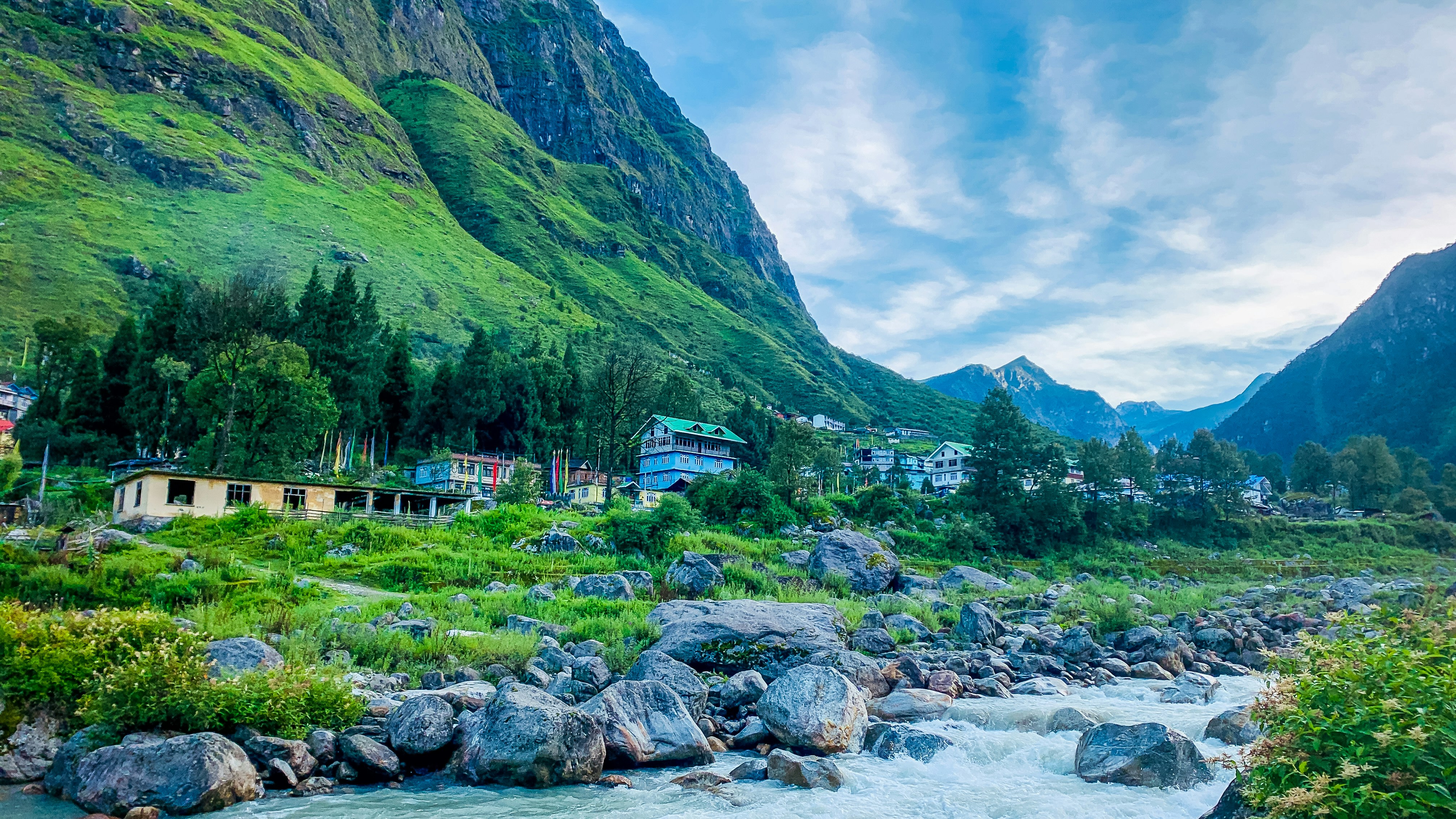 A scenic mountain village with a flowing river.