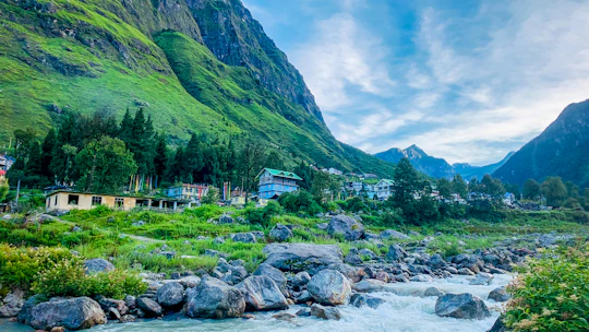 A scenic mountain village with a flowing river.