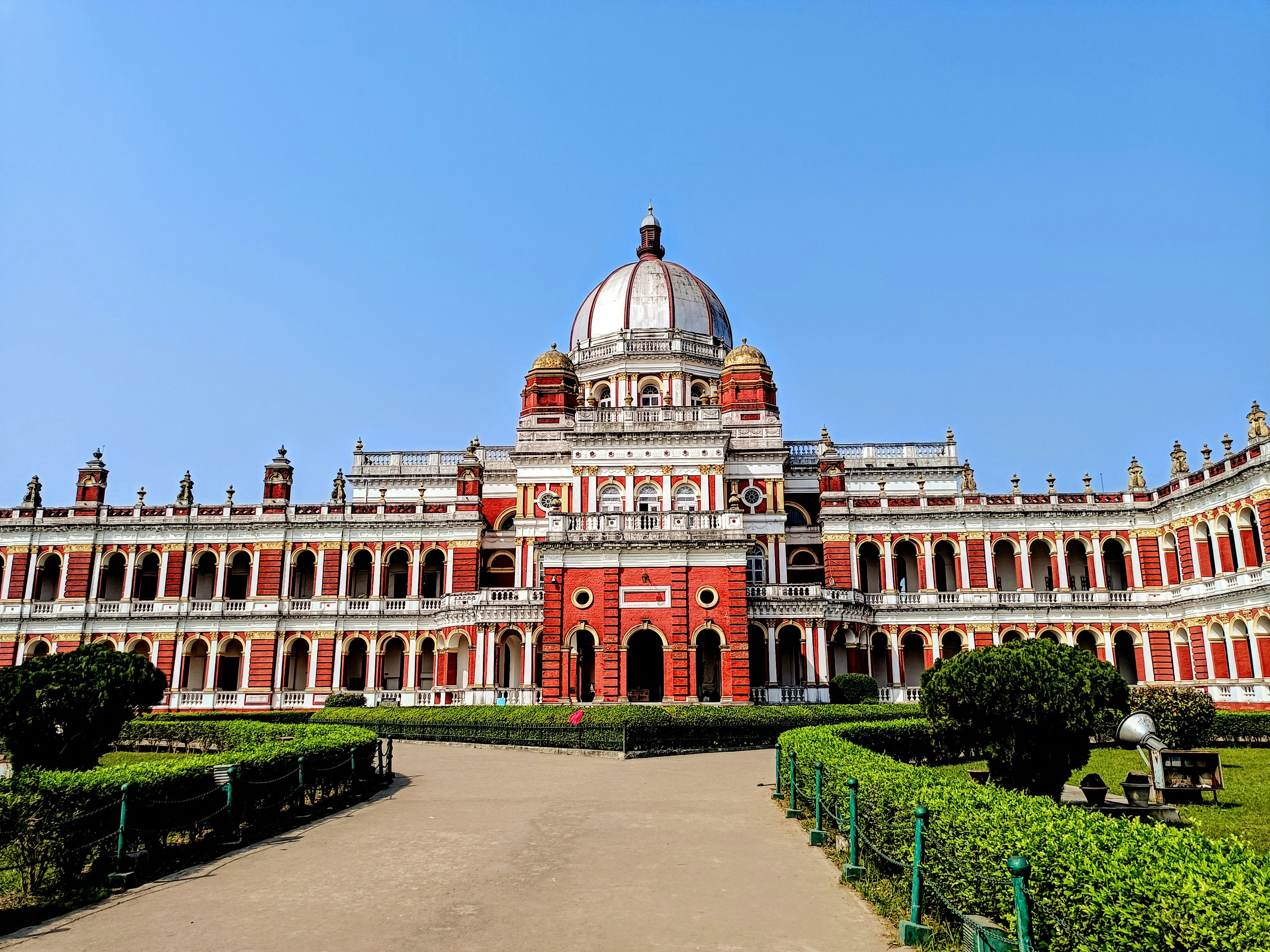 A grand palace stands under a clear blue sky.