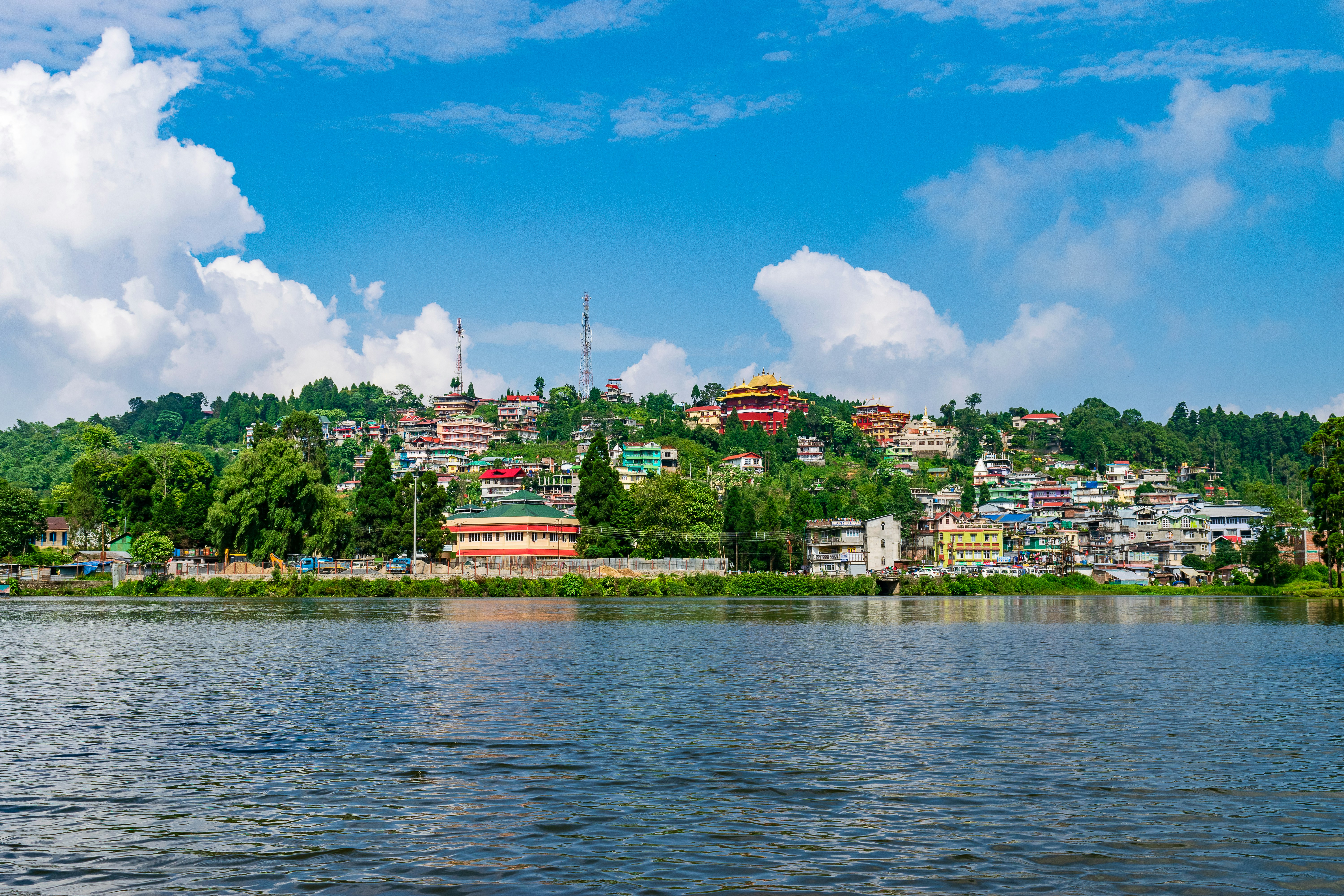 A scenic lake view with houses on the hillside.