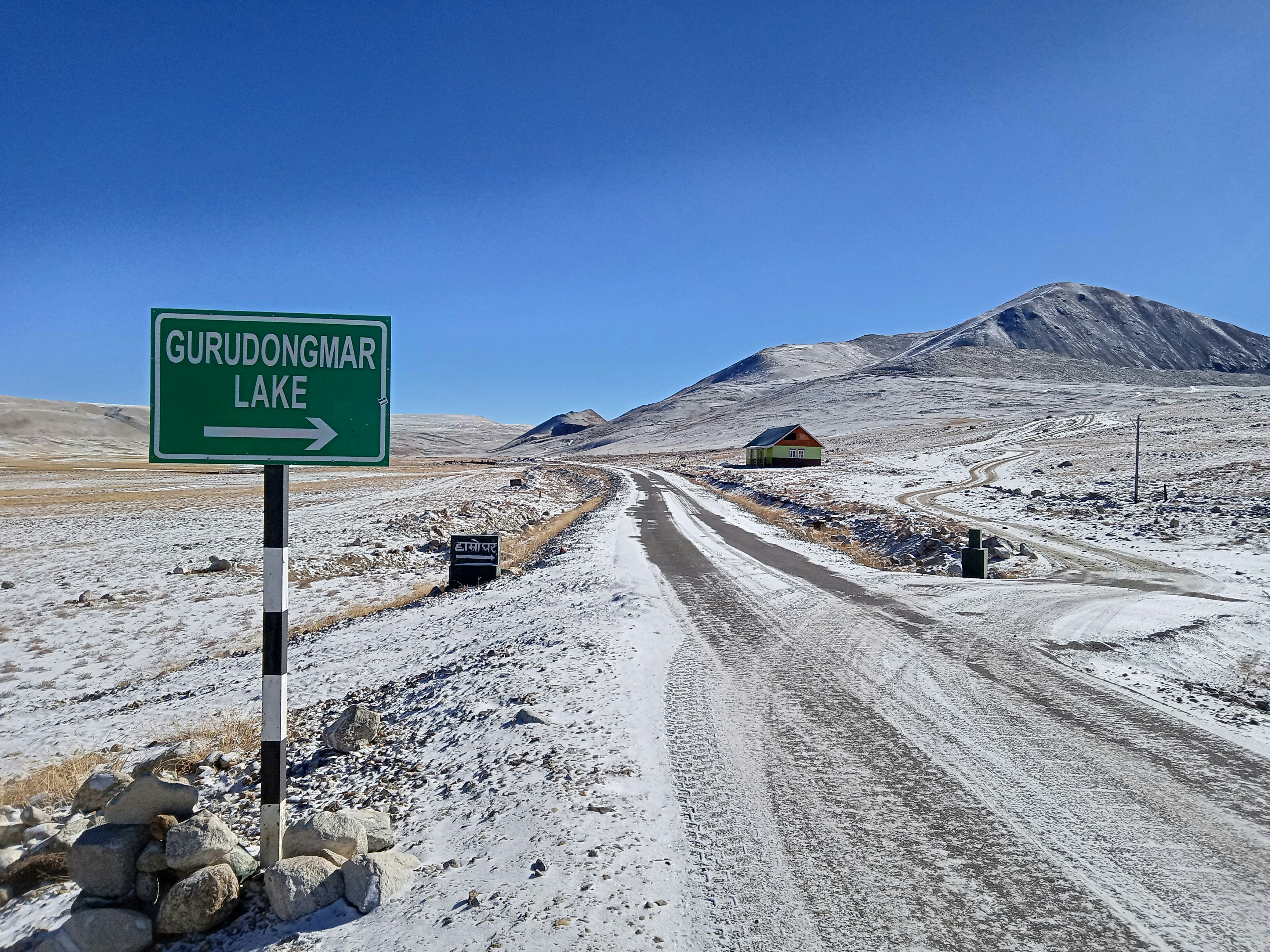 A snowy road leads to gurudongmar lake.