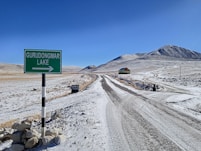 A snowy road leads to gurudongmar lake.